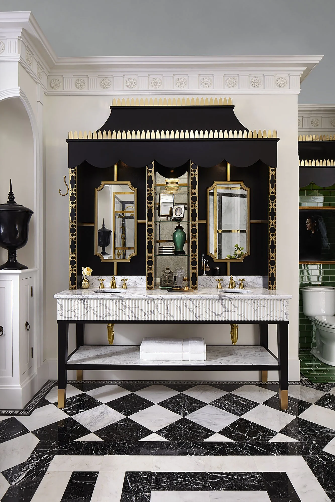 Elegant black and gold double vanity with mirrors, marble countertop, and decorative decor in a luxurious bathroom.