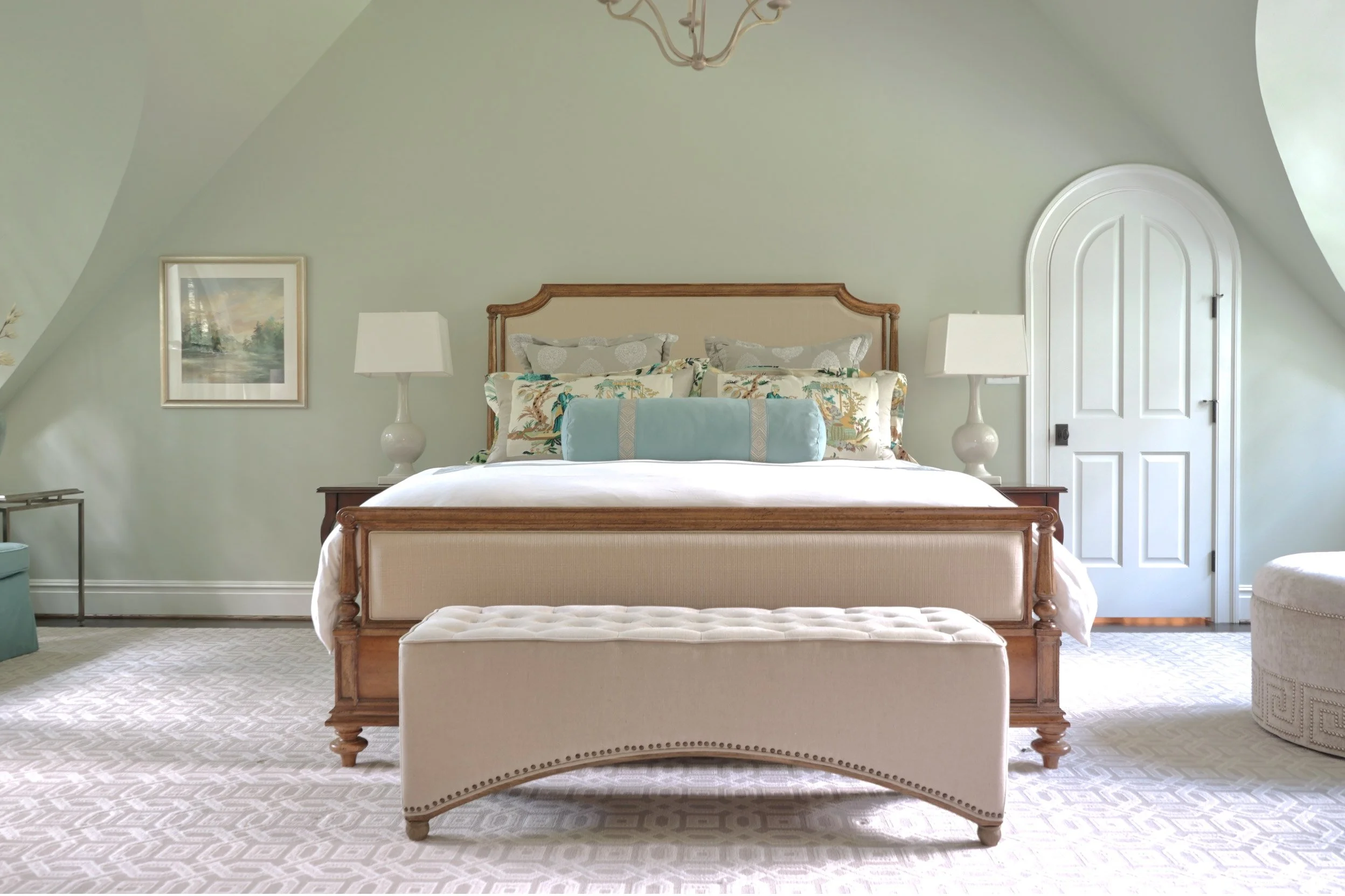 An image of a bedroom in green, blue, and pastel colors.