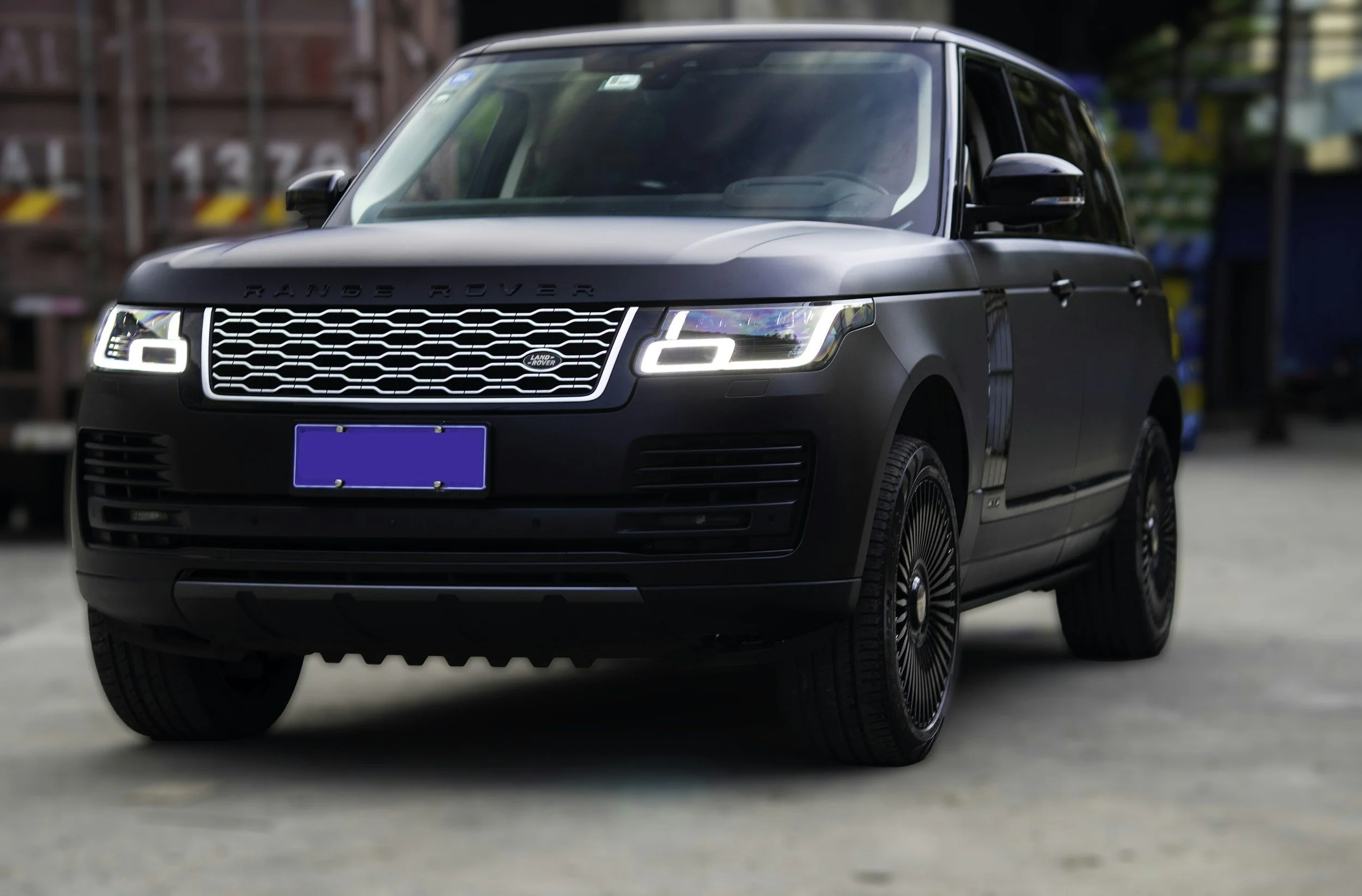 Black Range Rover SUV parked on an urban street with blurred background