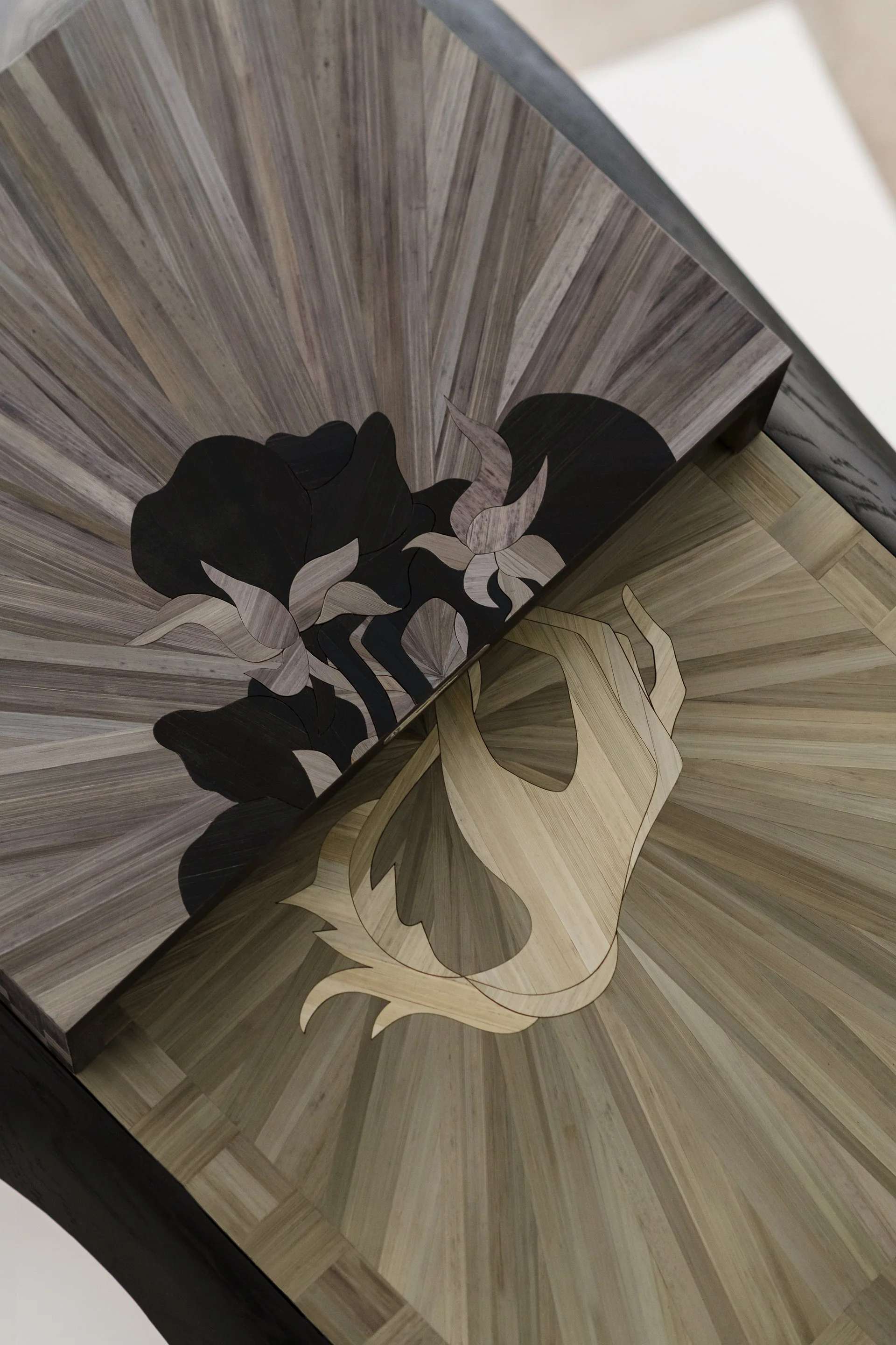 Wooden box with a design of a skull and roses inside.