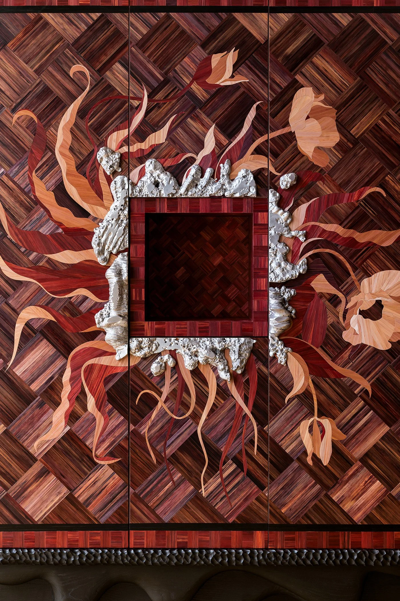 Decorative wooden wall panel with a floral motif, featuring a mix of reddish-brown and beige tones, with a central empty square frame surrounded by textured silver accents.