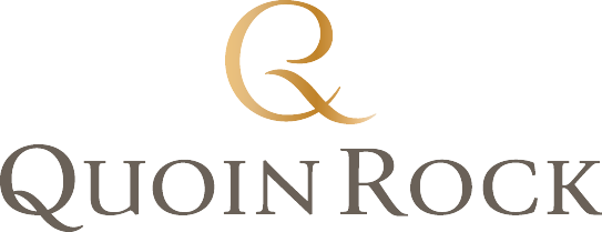 Quoin Rock logo in black and gold text.