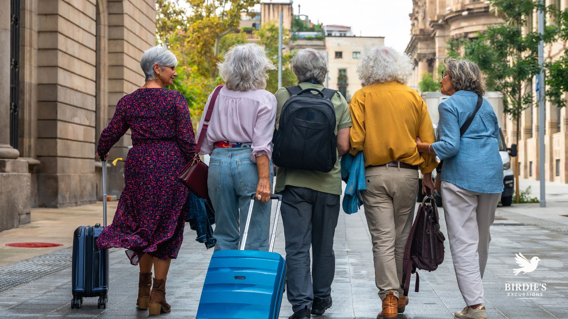 A group of women with travel bags and rolling luggage exploring the streets of a new destination