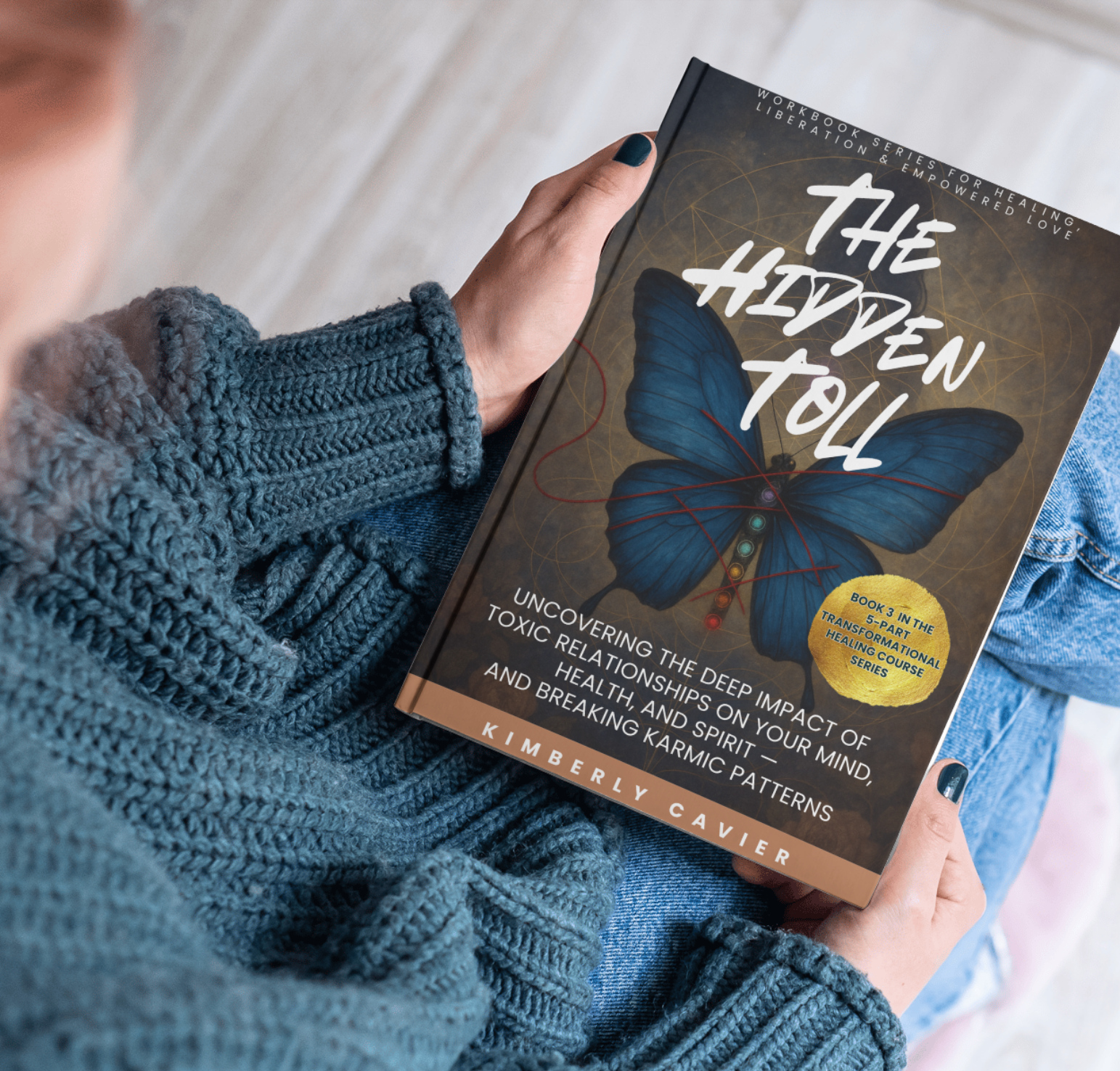 Person holding The Hidden Toll by Kimberly Cavier, a mind-body-soul healing workbook for women recovering from toxic relationships, trauma bonds, and narcissistic abuse.