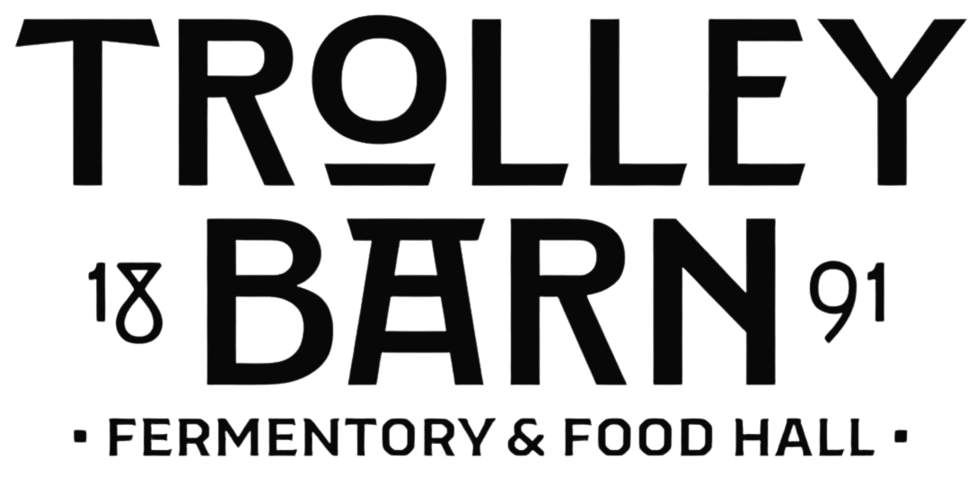 Black and white logo for Trolley Barn, a ferments and food hall, established in 1891.
