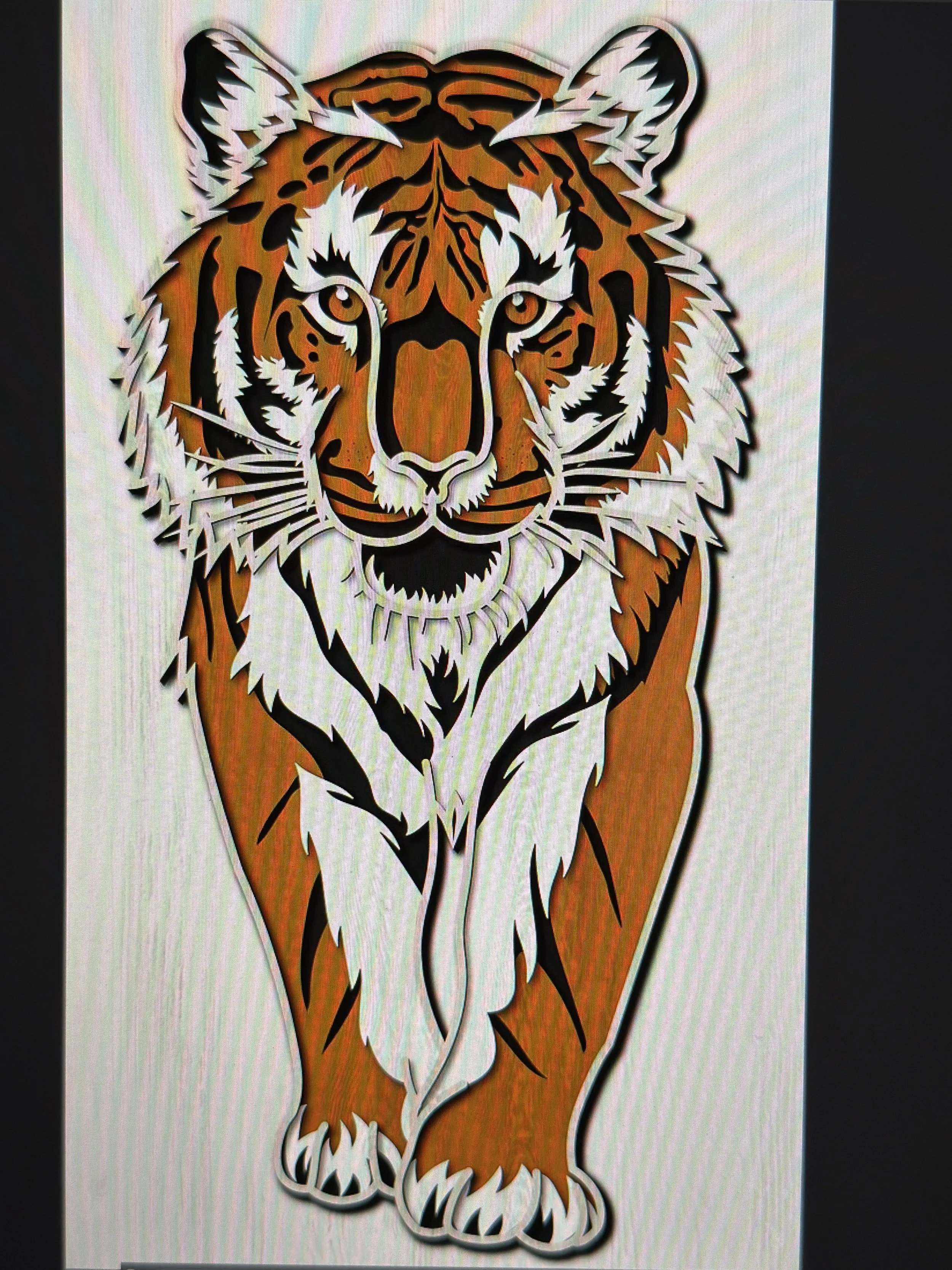 Colorful paper cut-out of a tiger with intricate details and bold black outlines.