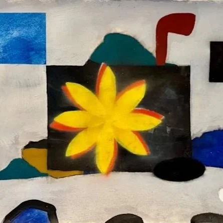 A black rectangular object with a yellow and orange flower painted on it, surrounded by various shapes and colors in the background.
