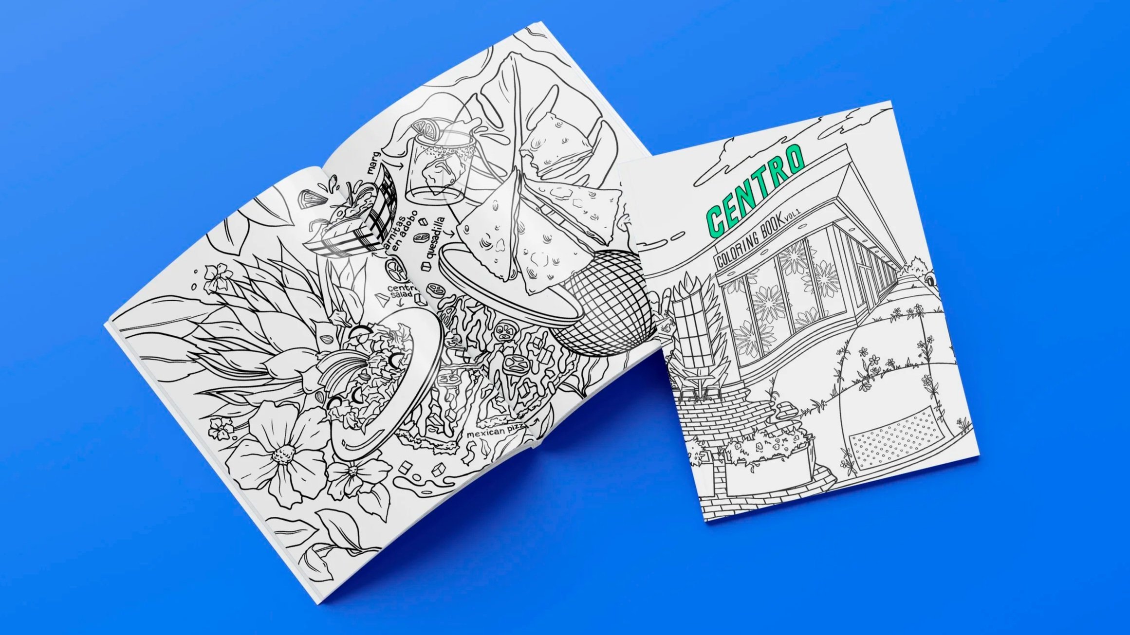 Open coloring book with illustrations of food, plants, and a building, on a blue background.