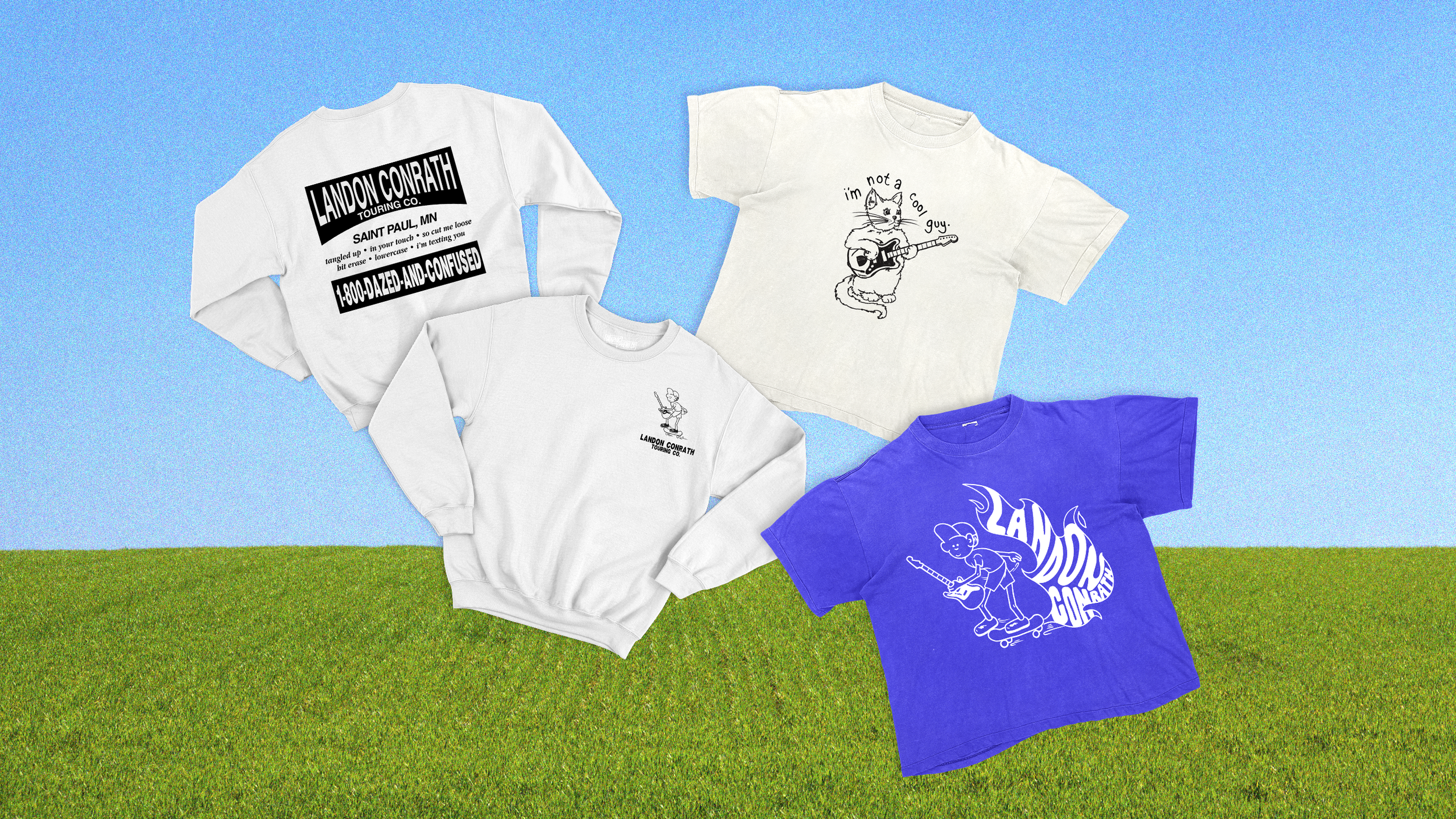 Four casual shirts laid out on a grassy field with a blue sky background. The shirts feature various black and white and colorful graphics, including a cat with a guitar, a small person with a sword, and a skateboarder with the text "LANDON CONRATH".