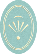 A vintage-style oval mirror with gold trim and decorative detailing