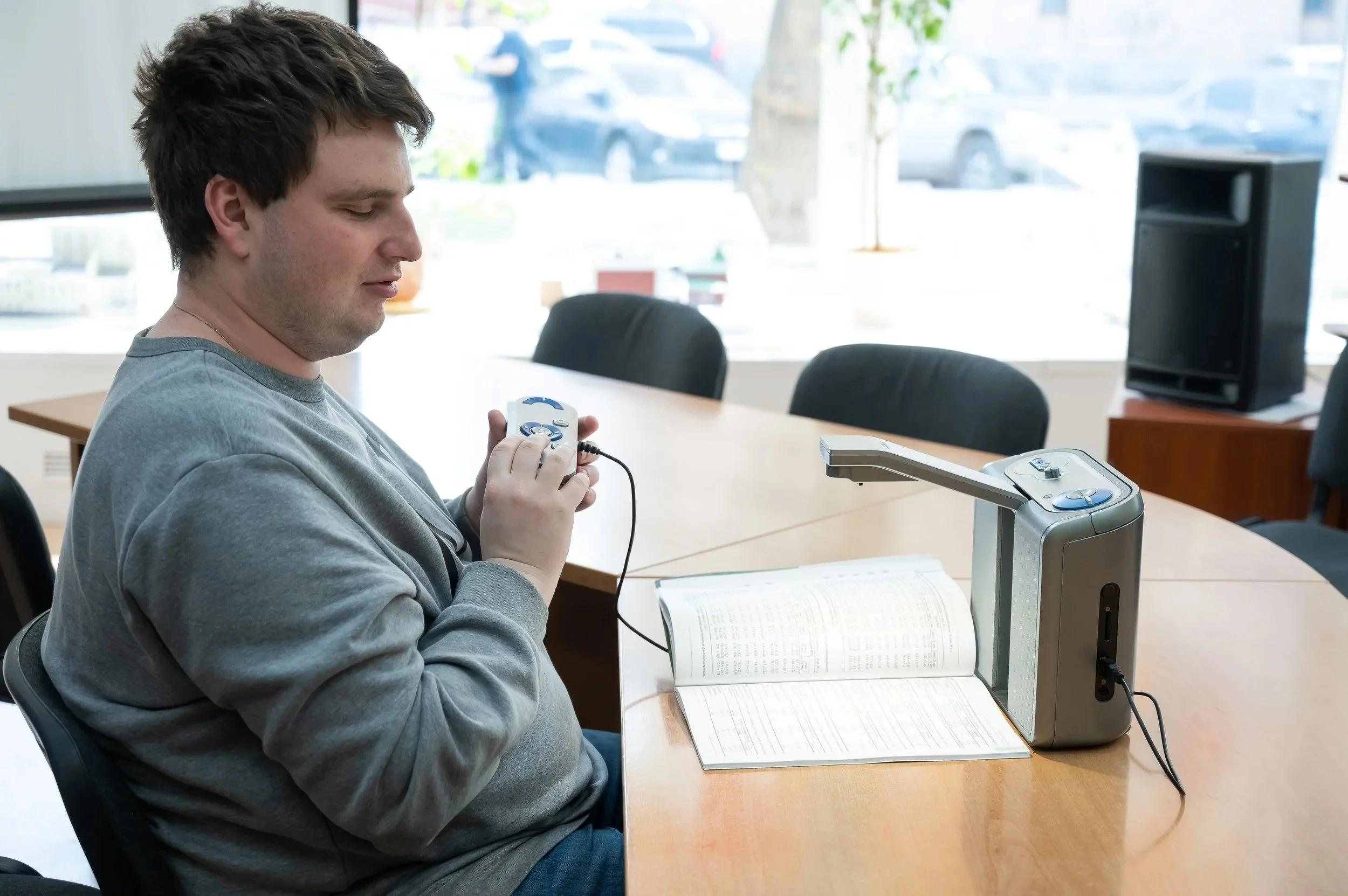 A man reads from a braille device
