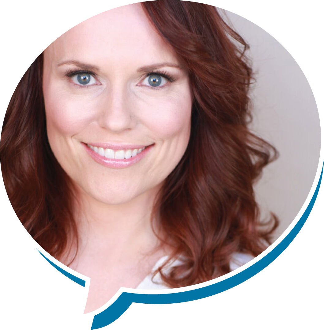 Close-up of a woman with red hair and blue eyes smiling.