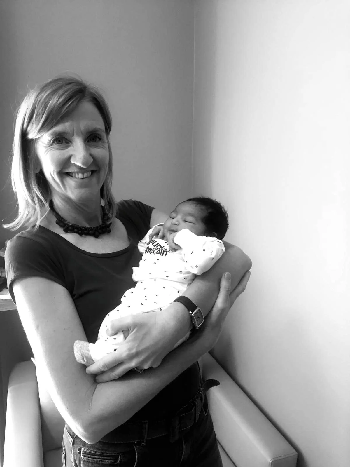 Jaen Piot holding a baby