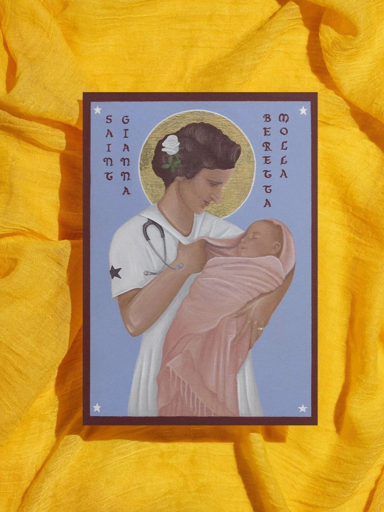 Illustration of a Gianna Mola holding a newborn baby, with a golden halo around her head, on a light purple background, surrounded by yellow fabric.