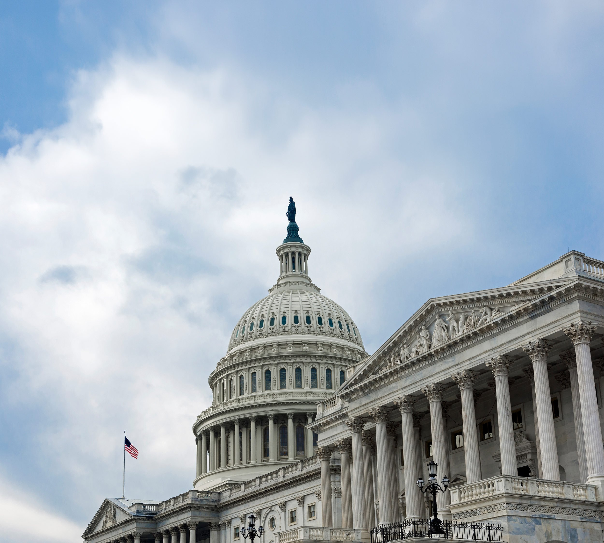 U.S. Capitol dome against a cloudy blue sky