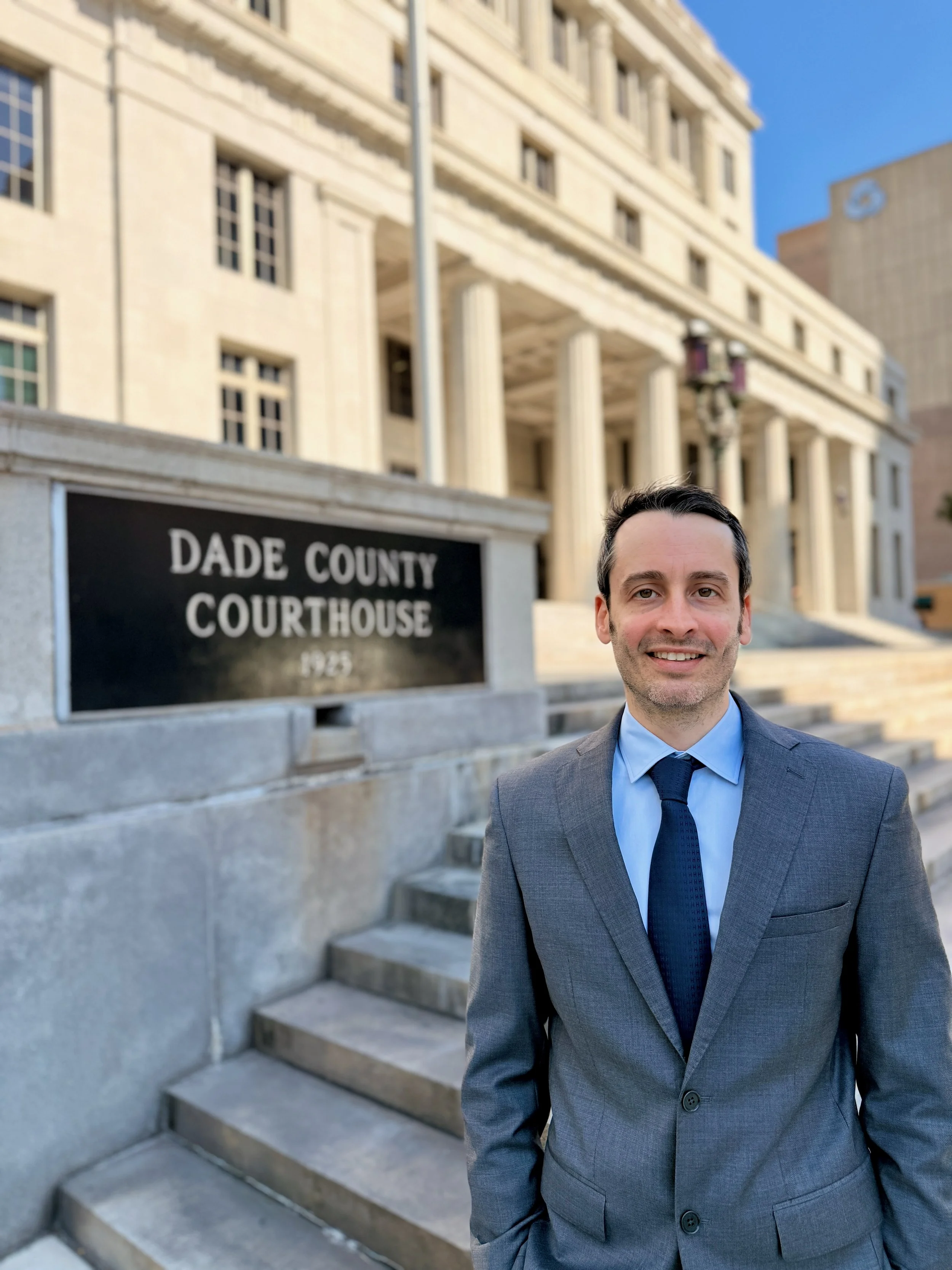 Man in gray suit standing outside Dade County Courthouse in Miami Florida