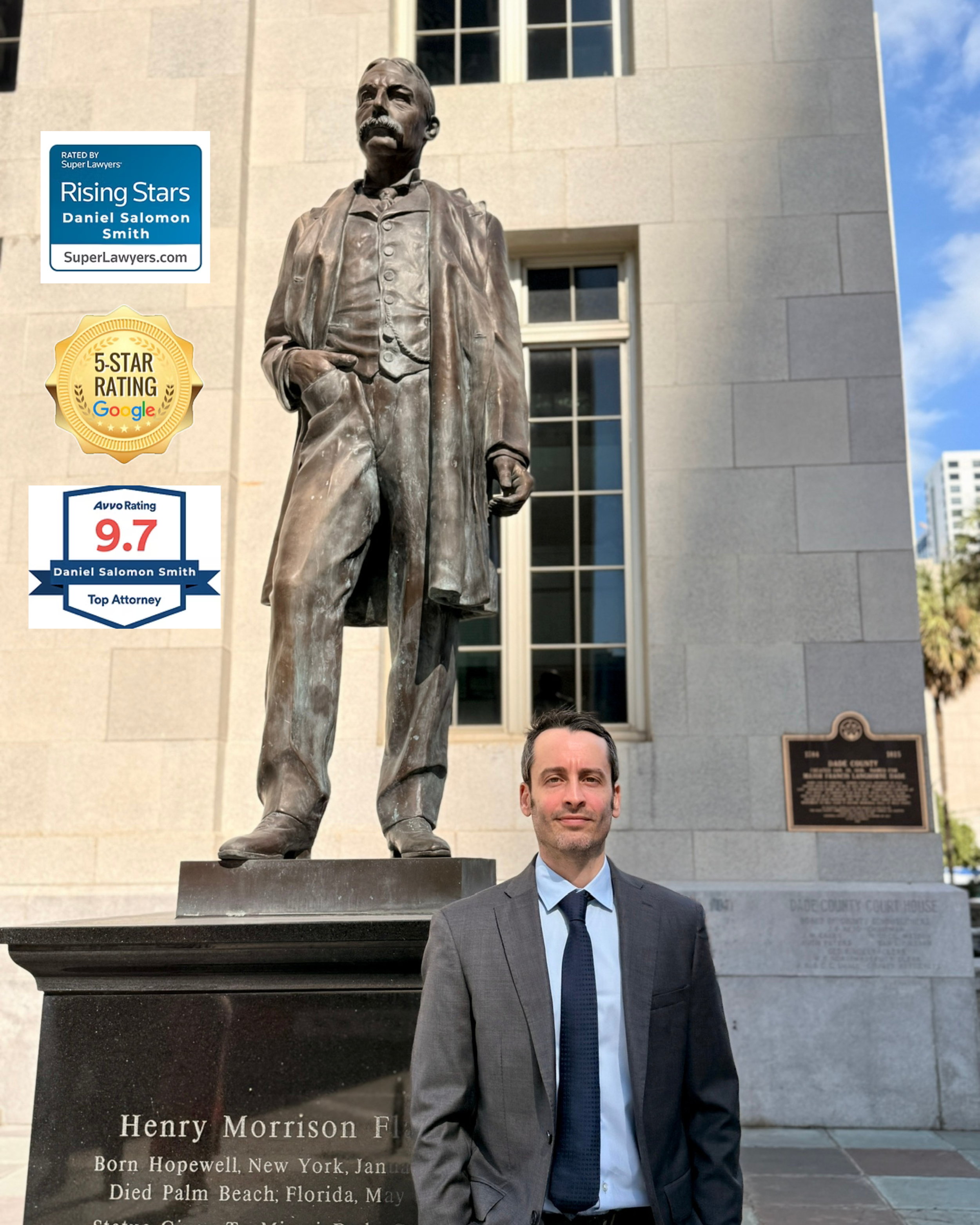 A man in a gray suit standing in front of a statue of Henry Morrison Flipper outside a courthouse.