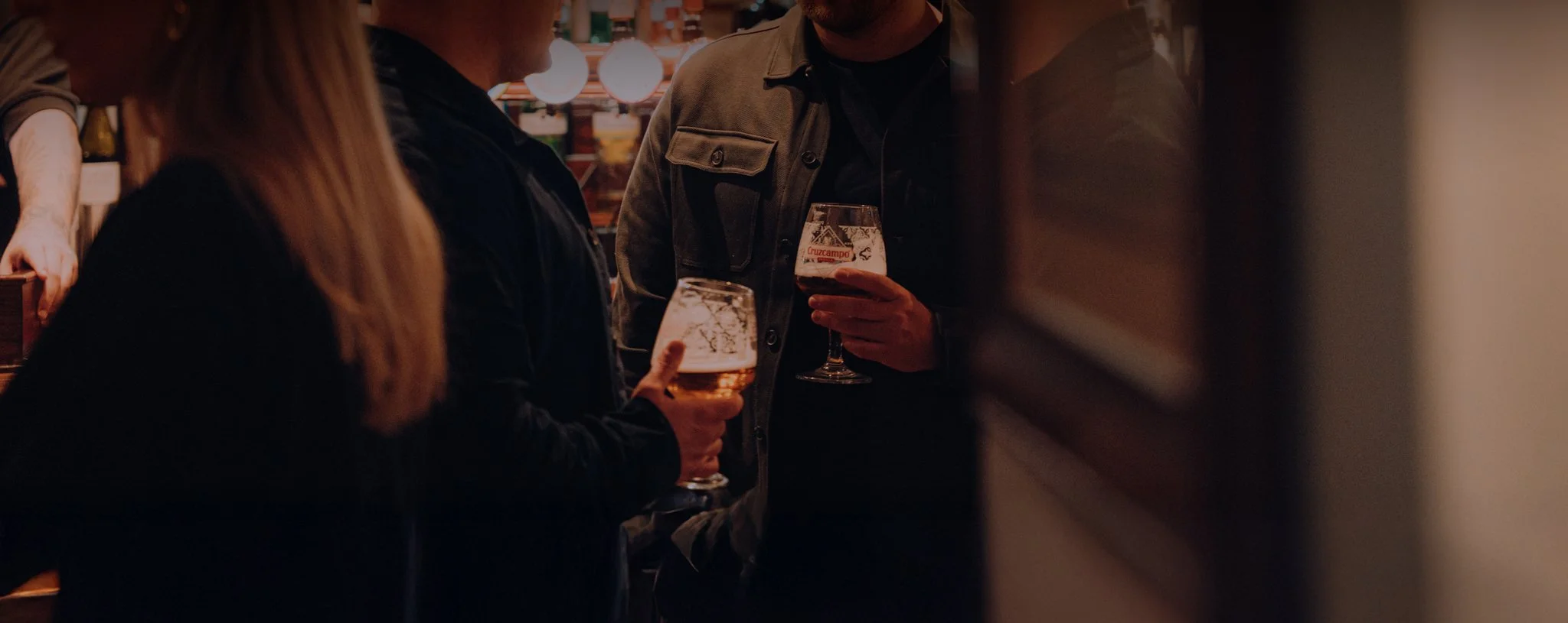 People holding pints of beer in a pub The George Stephenson, engaged in conversation, having fun.