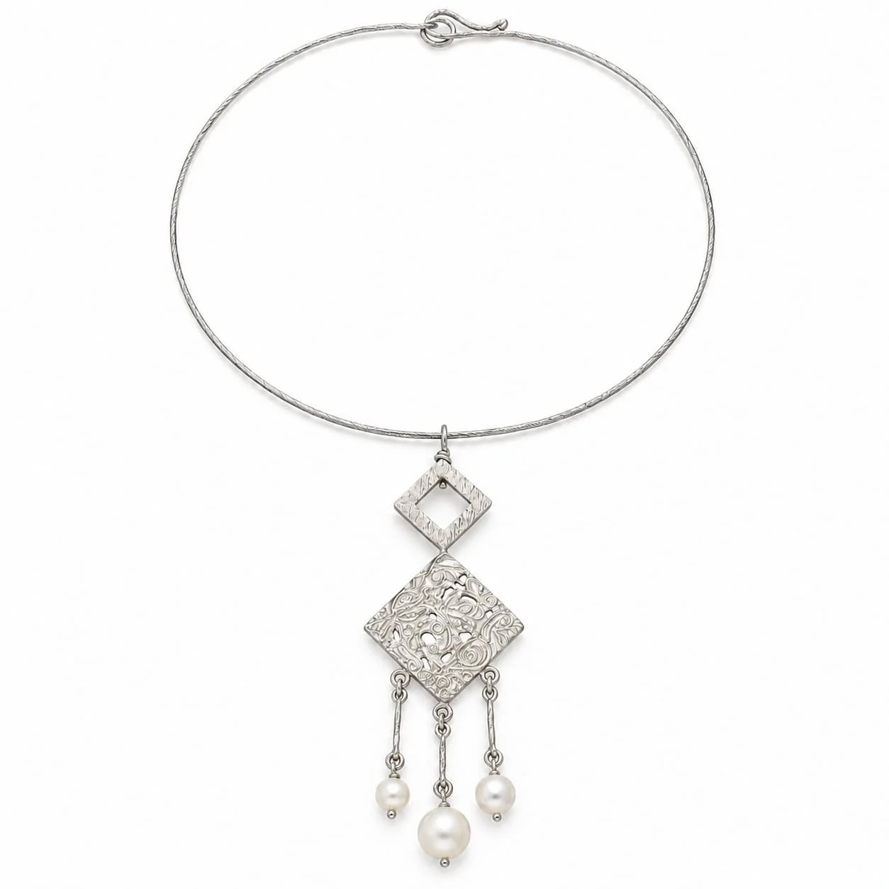 Intricate silver charm with white perforations.jpg