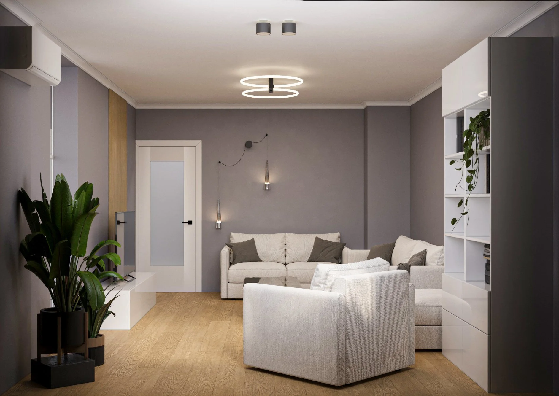 Modern living room with beige sofas, gray walls, wooden flooring, a large green potted plant on the left, ceiling lights, and a white bookshelf on the right.