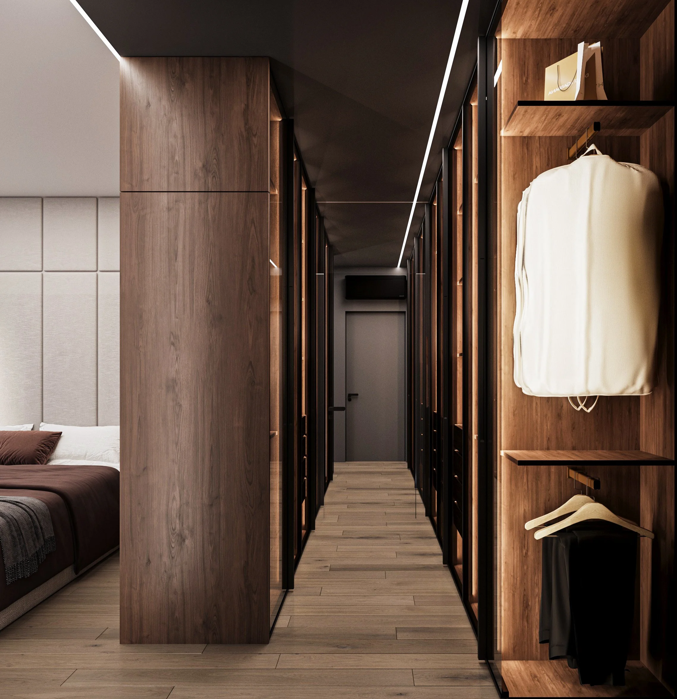 Modern bedroom with a wooden and glass closet partition, a bed with brown and gray bedding on the left, and a hallway leading to a door at the back.