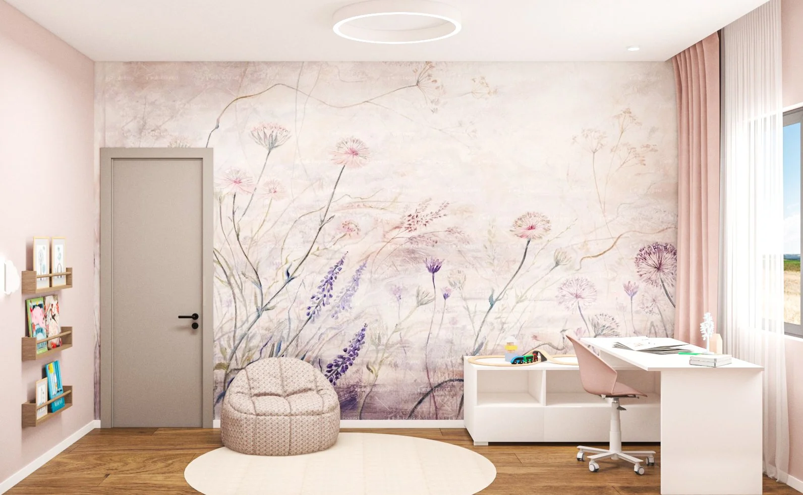 A children's bedroom with pastel pink walls and a floral mural. There is a round, beige pouf, a white desk with a pink chair, and a window with pink curtains.
