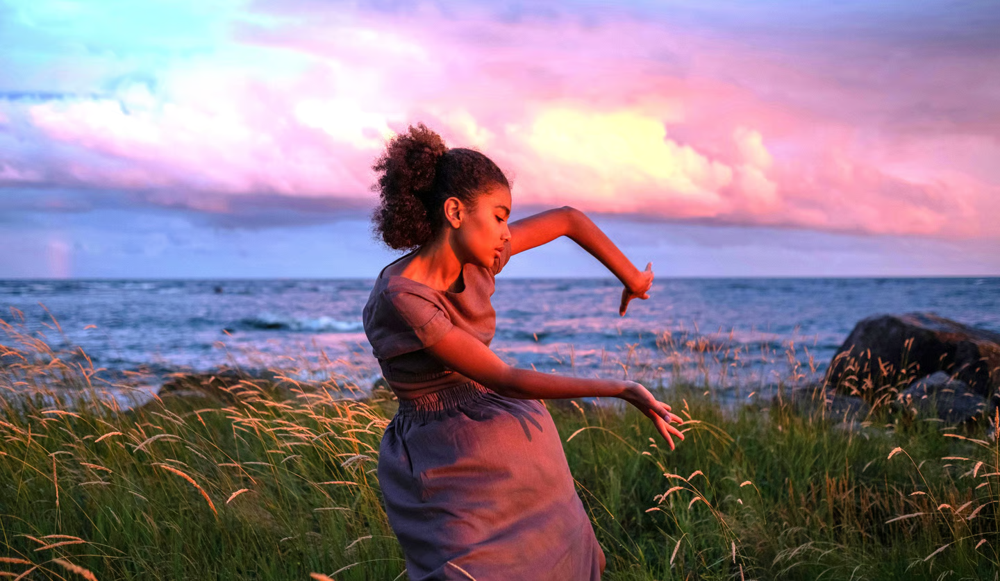 Rockin Healthy Vibes - a lady dancing in the sunset hours by the ocean