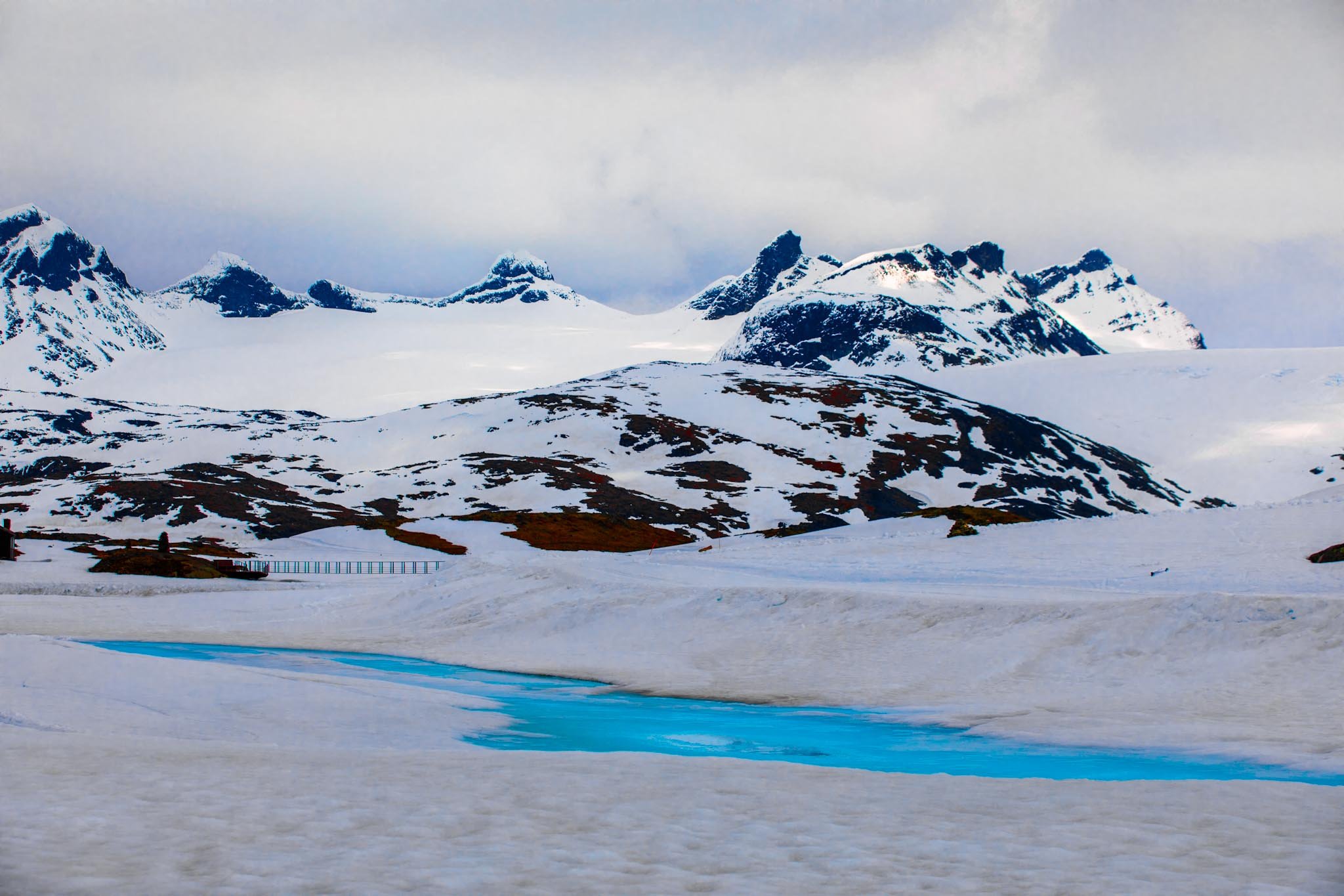Snow-covered mountains in Norway under flat overcast light with no strong shadows