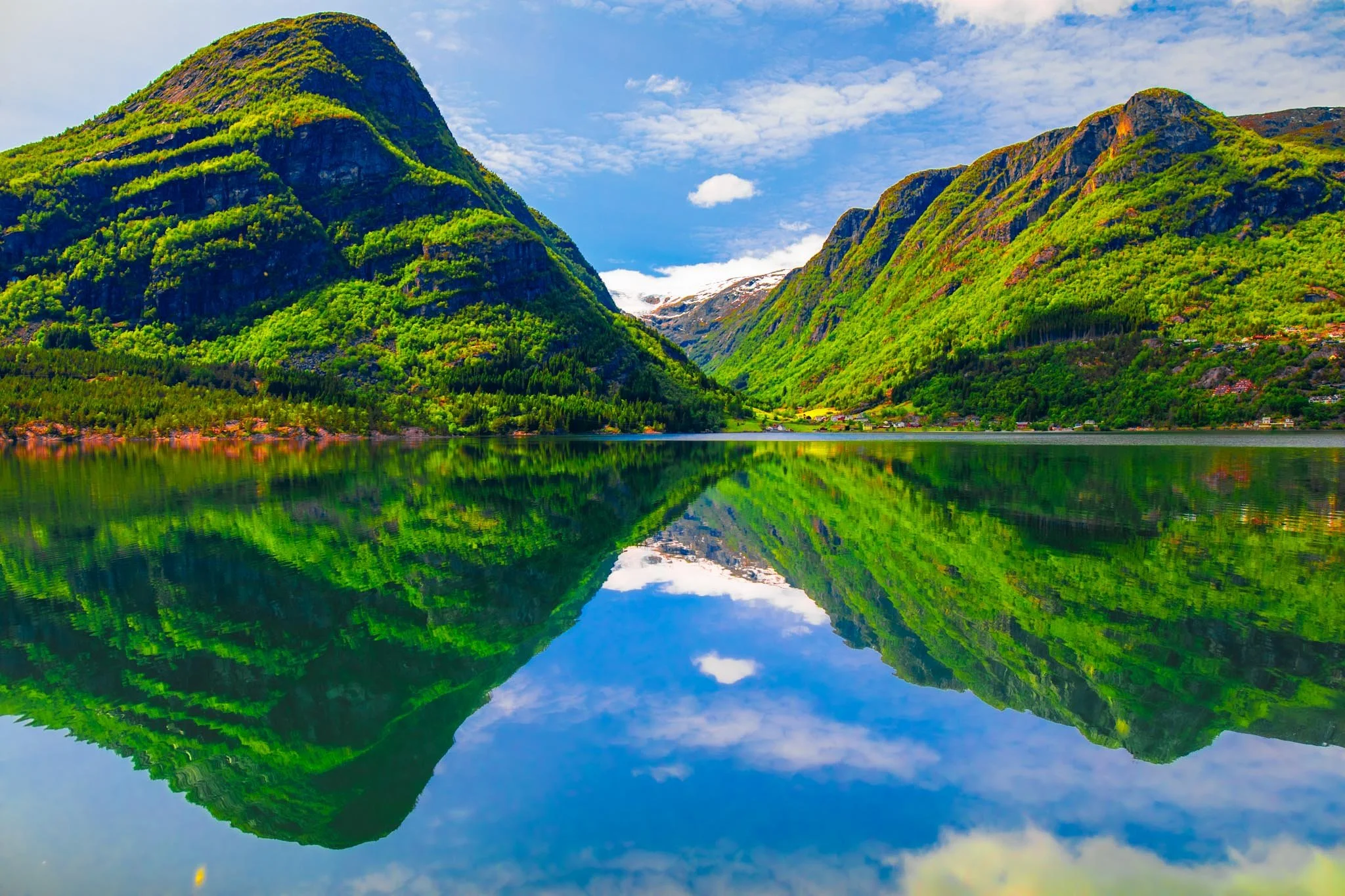 Mountain lake in Norway with perfect reflection under soft even light and clear sky