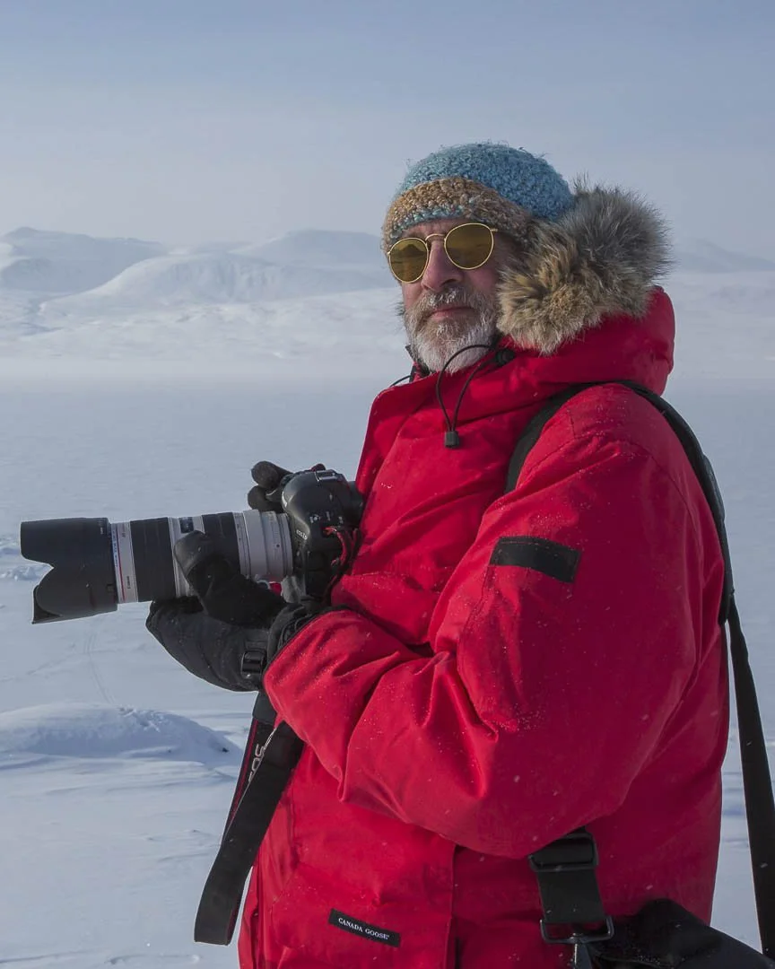 Male photographer holding camera