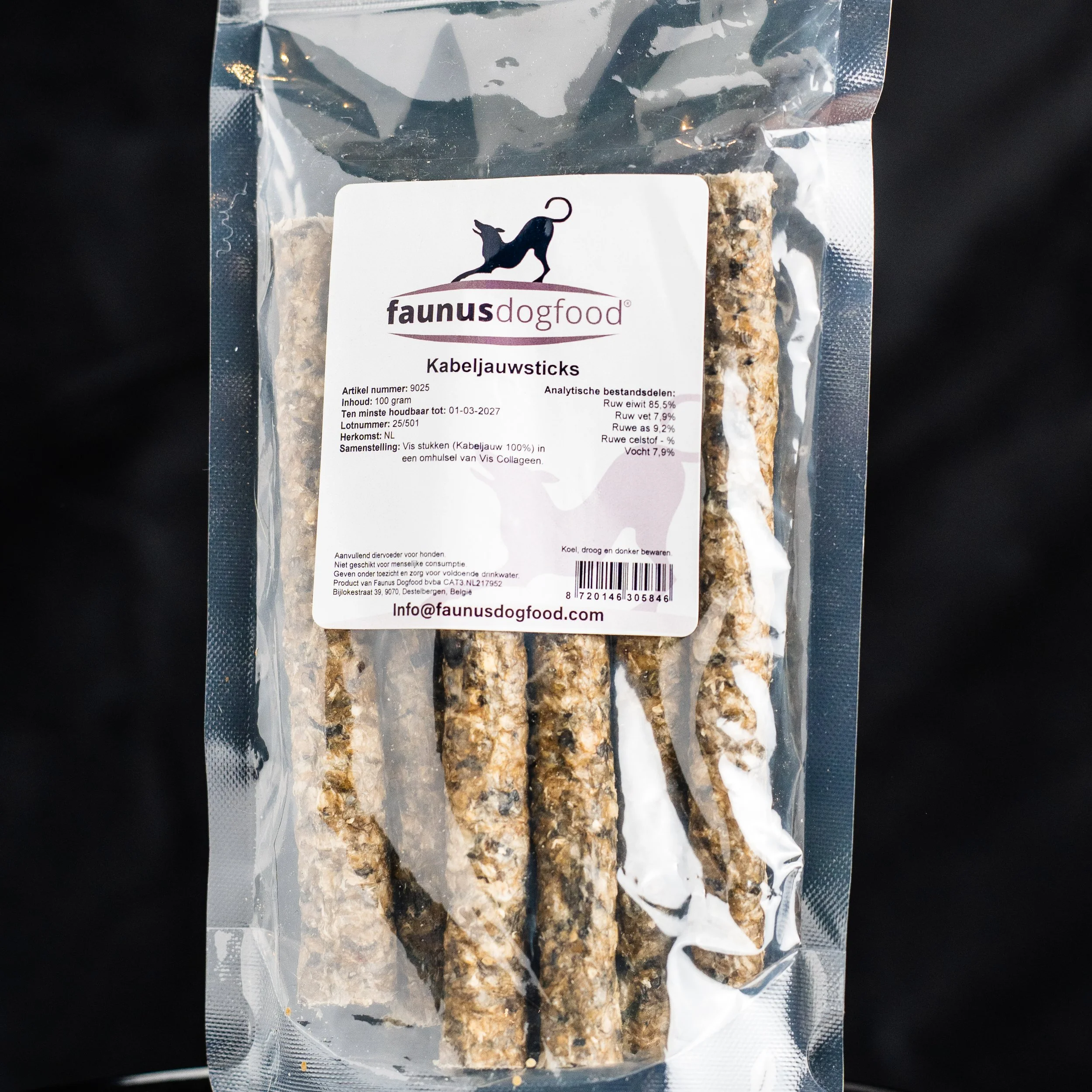 Packaged dog treat sticks labeled 'Kabeljauwsticks' from Faunus Dog Food, with a logo of a black dog silhouette and product information on the label.