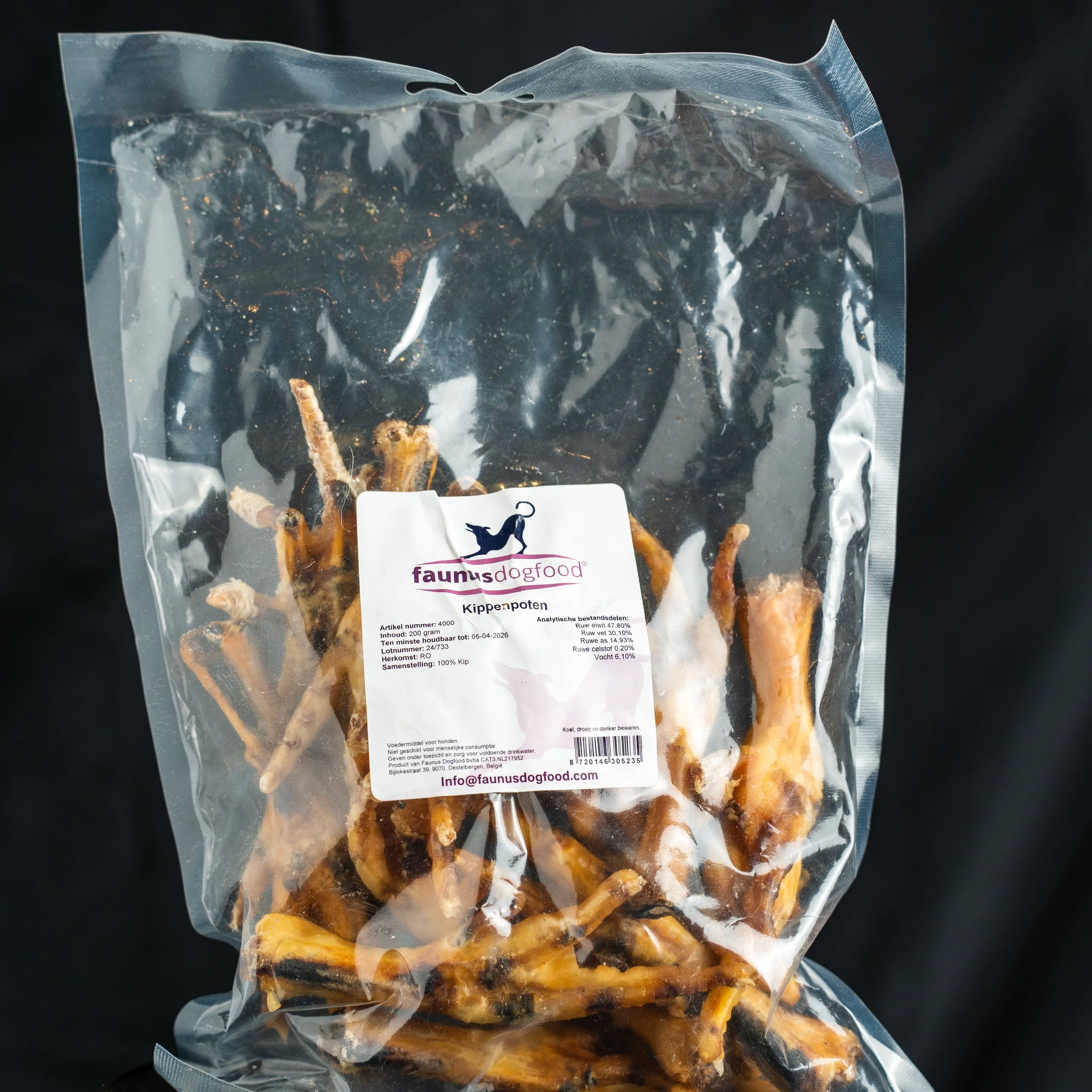 Vacuum-sealed package of chicken paws from Fauna's dog food brand, with a label displaying product information and website details.