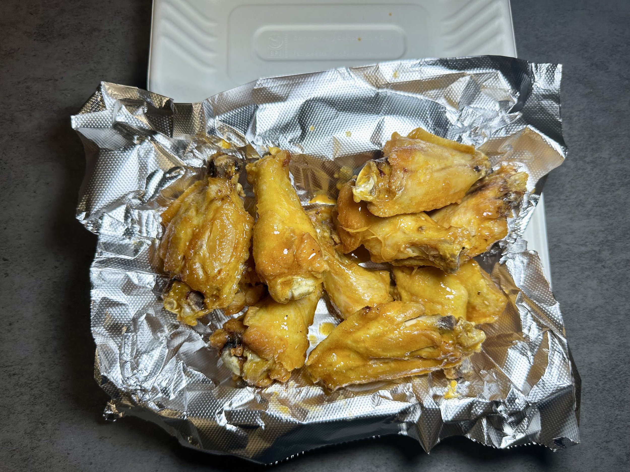 Fried chicken wings on aluminum foil