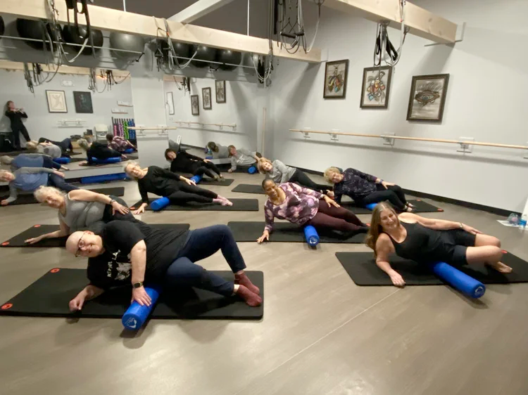 People exercising with foam rollers doing the Melt Method