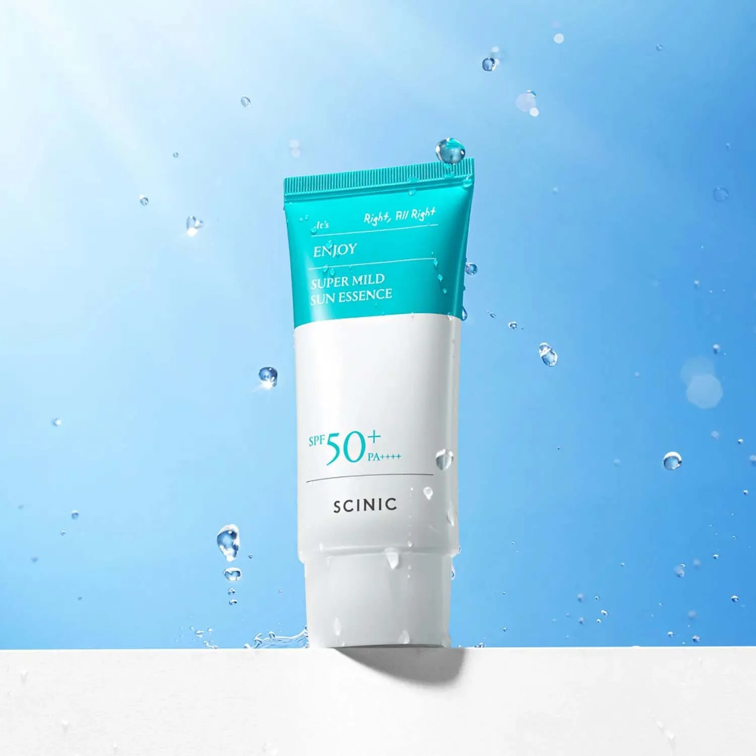 scinic super mild sun essence spf50+ in a sky background with a sun flare