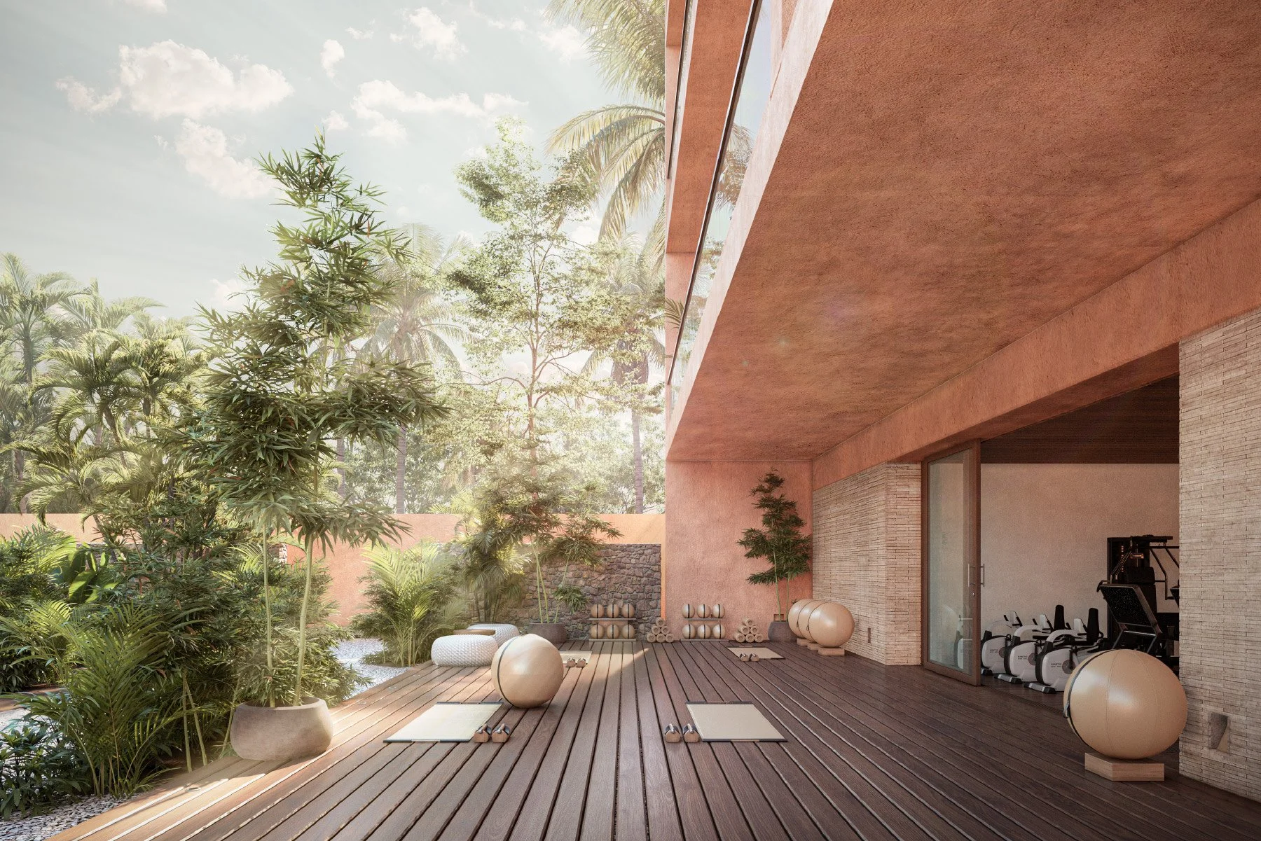Terraza al aire libre equipada para yoga y ejercicio, con colchonetas, pelotas y pesas, rodeada de plantas y árboles tropicales bajo cielo soleado.