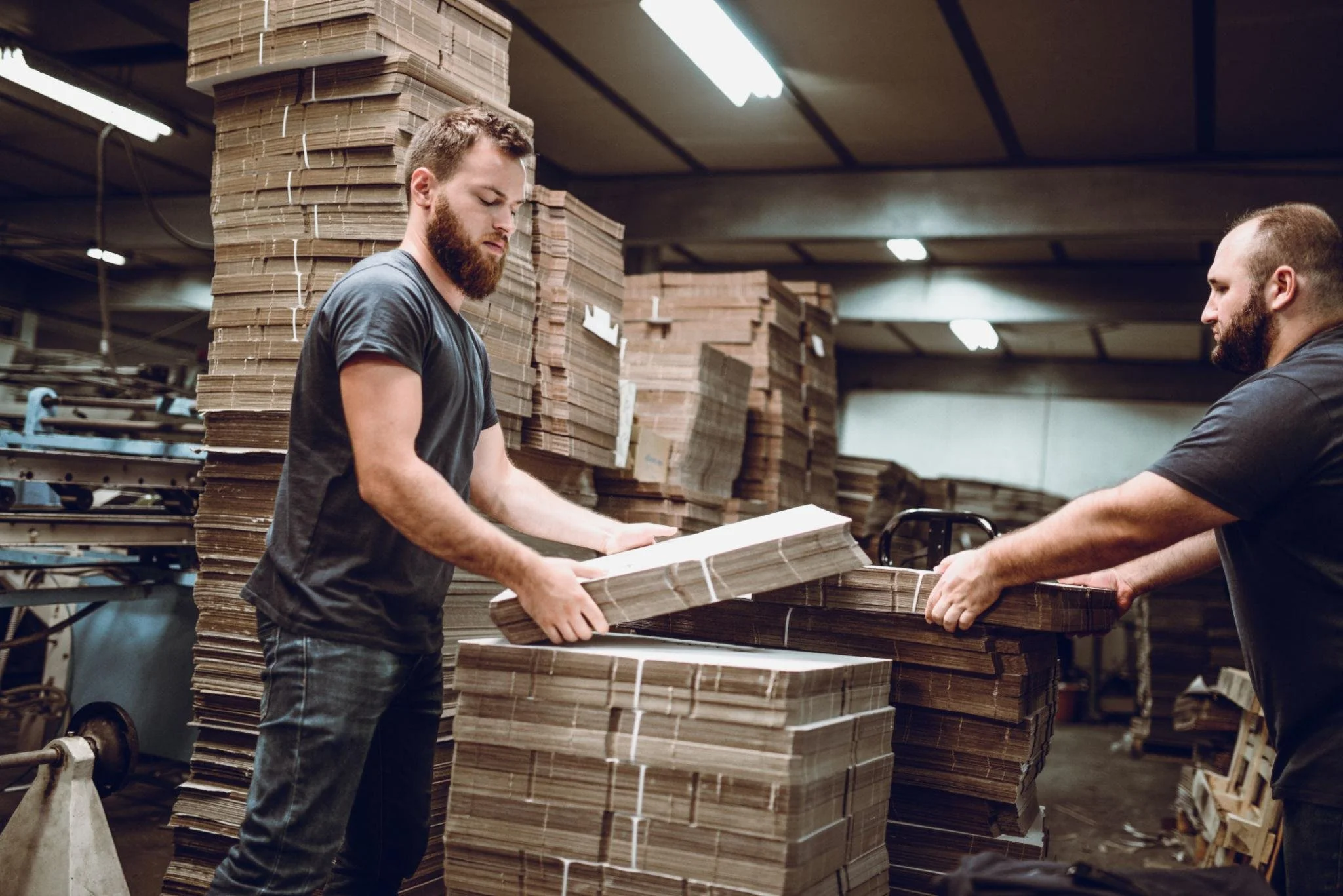 Two workers getting ready for their shift of manual palletizing