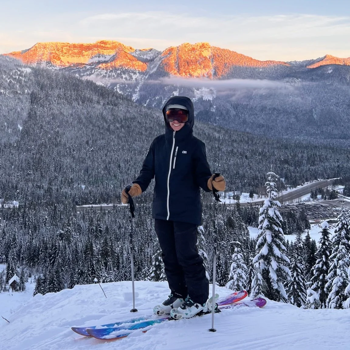 Female backcountry skier with alpenglow