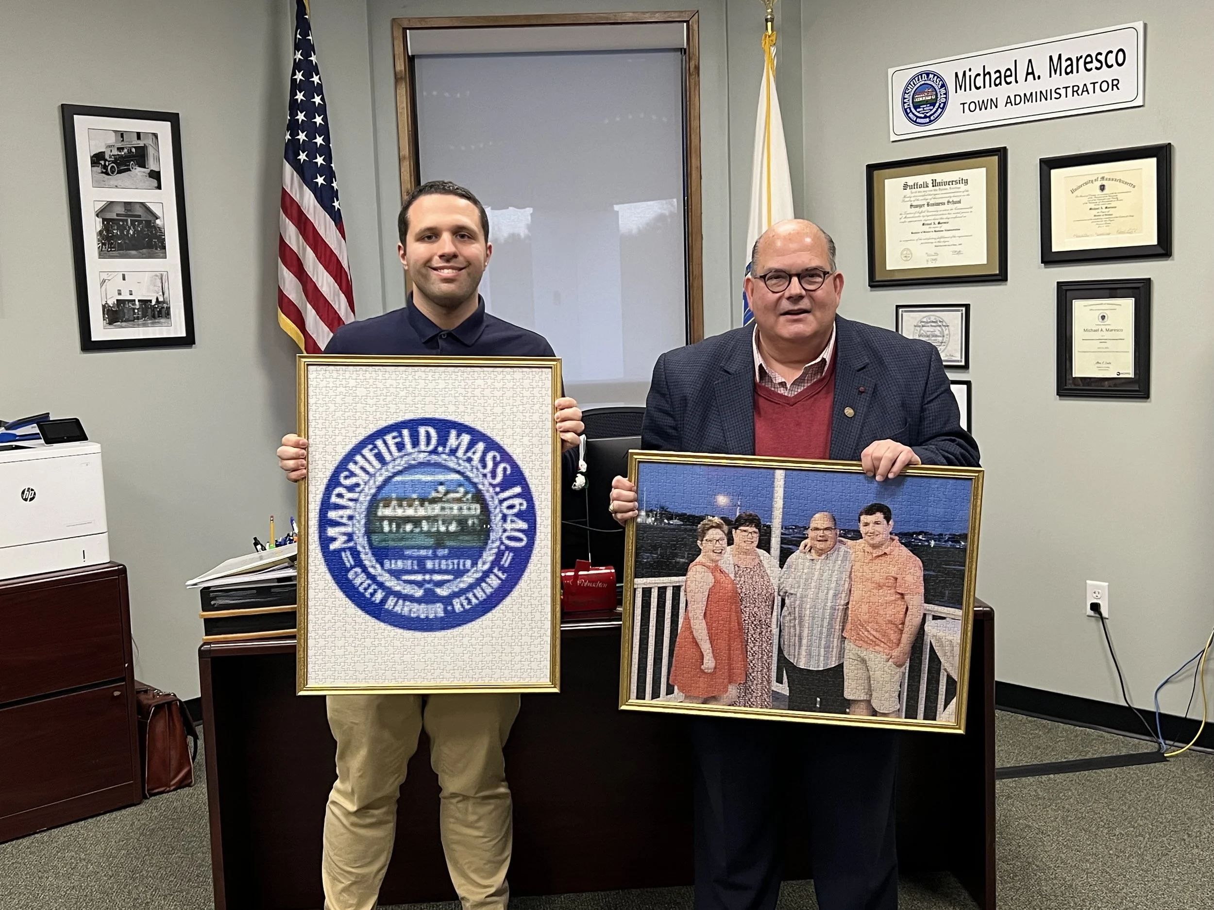 Former town administrator of Marshfield, MA Michael Maresco received a puzzle of his family and the Marshfield, MA town seal.