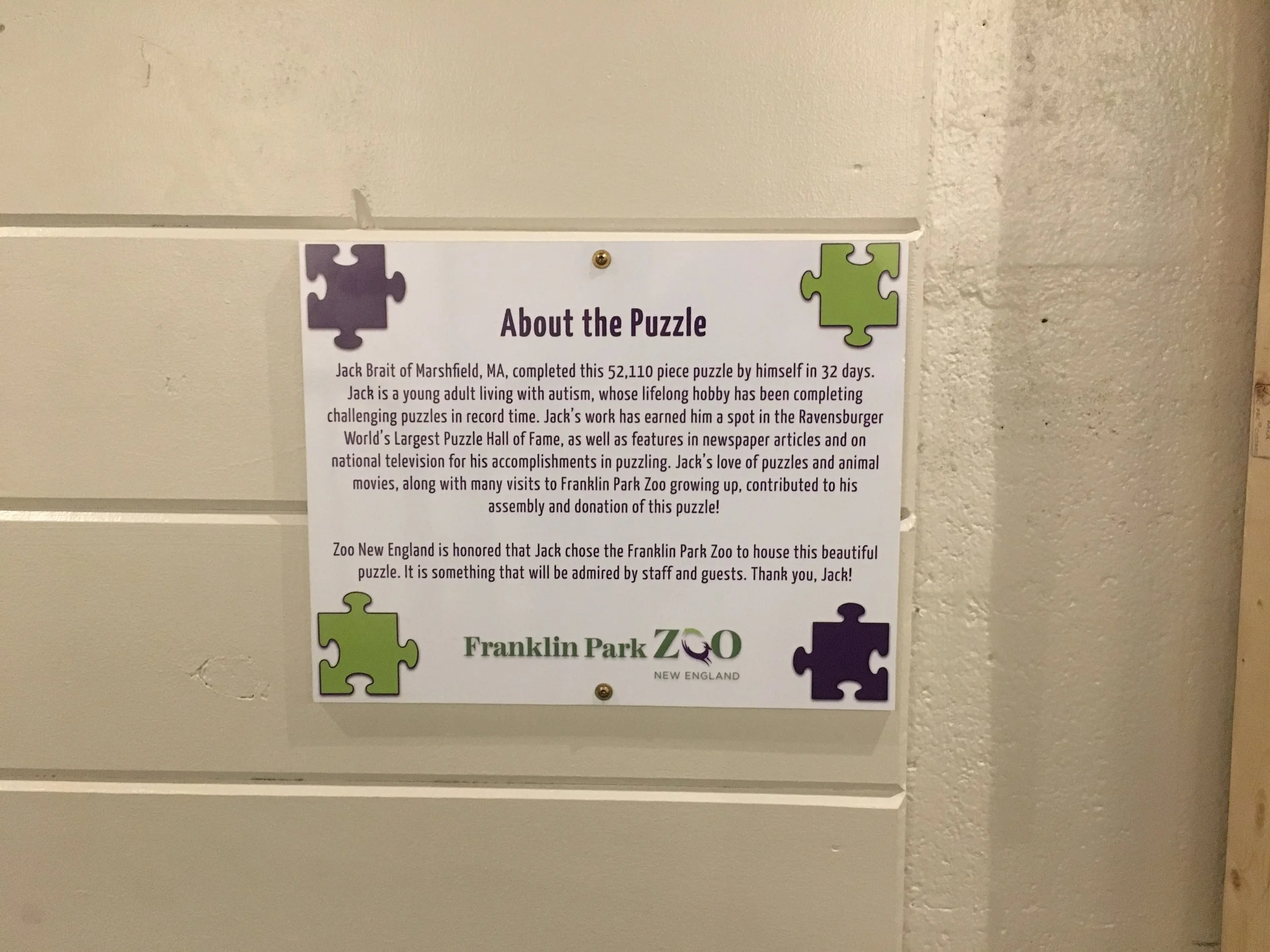 The plaque of the 52,110 piece puzzle by MartinPuzzle at the Franklin Park Zoo in Boston, MA