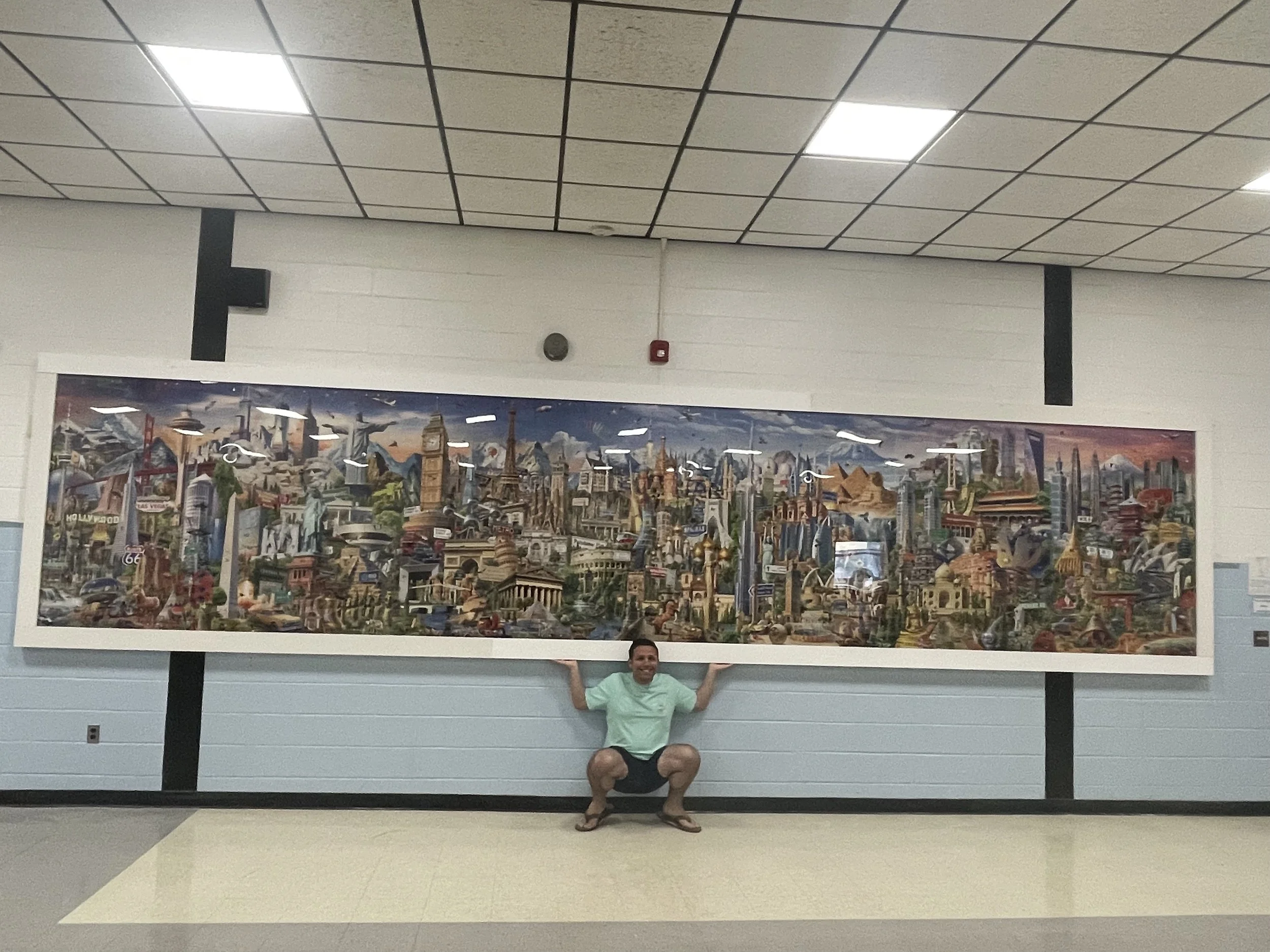 Jack Brait, aka Jack Of Puzzles, and the 42,000 piece puzzle by educa borrows puzzles, the world's largest puzzle, at Governor Winslow school in Marshfield, MA