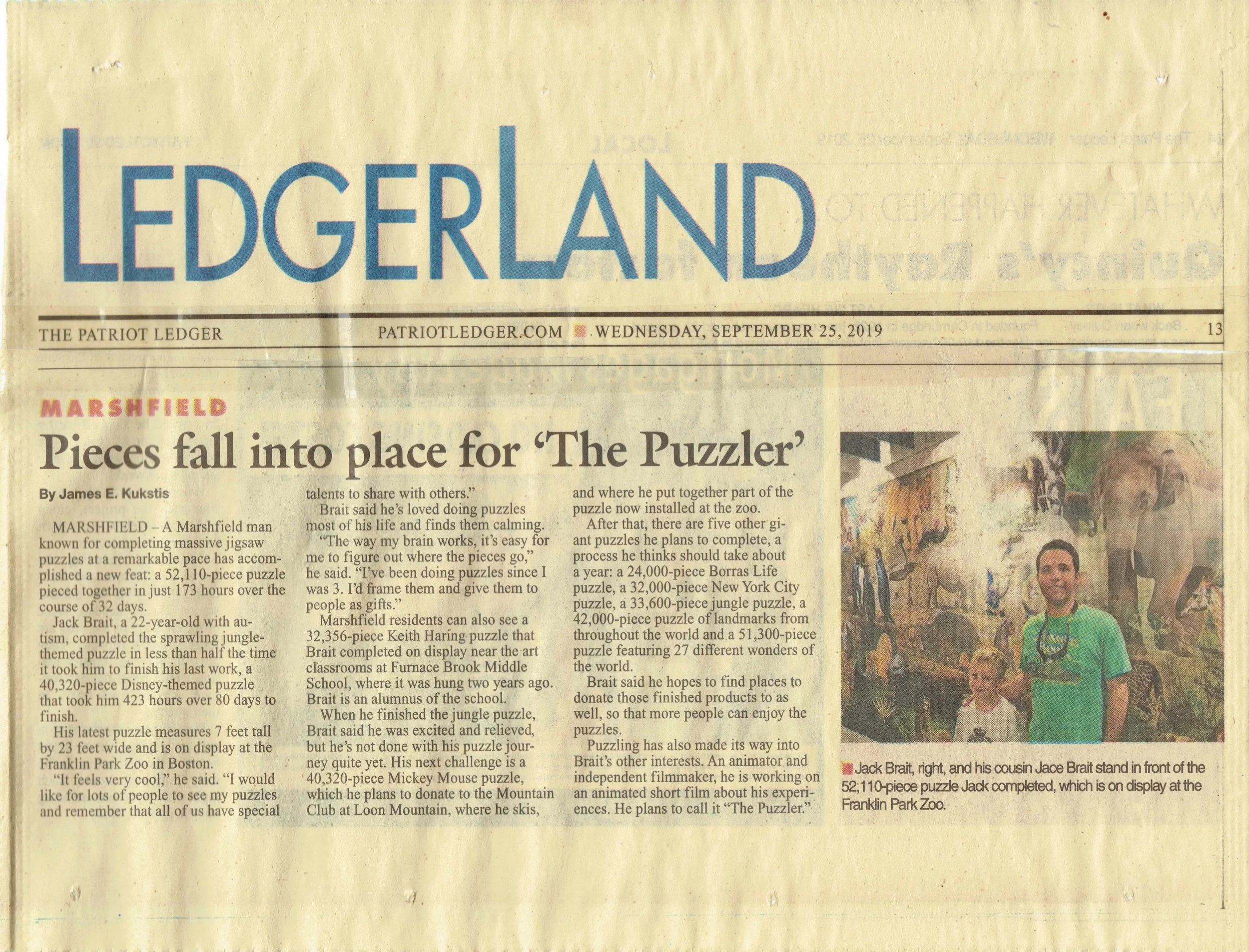 Jack Brait, aka Jack Of Puzzles, in the front of his Patriot Ledger article about the 52,110 piece puzzle A