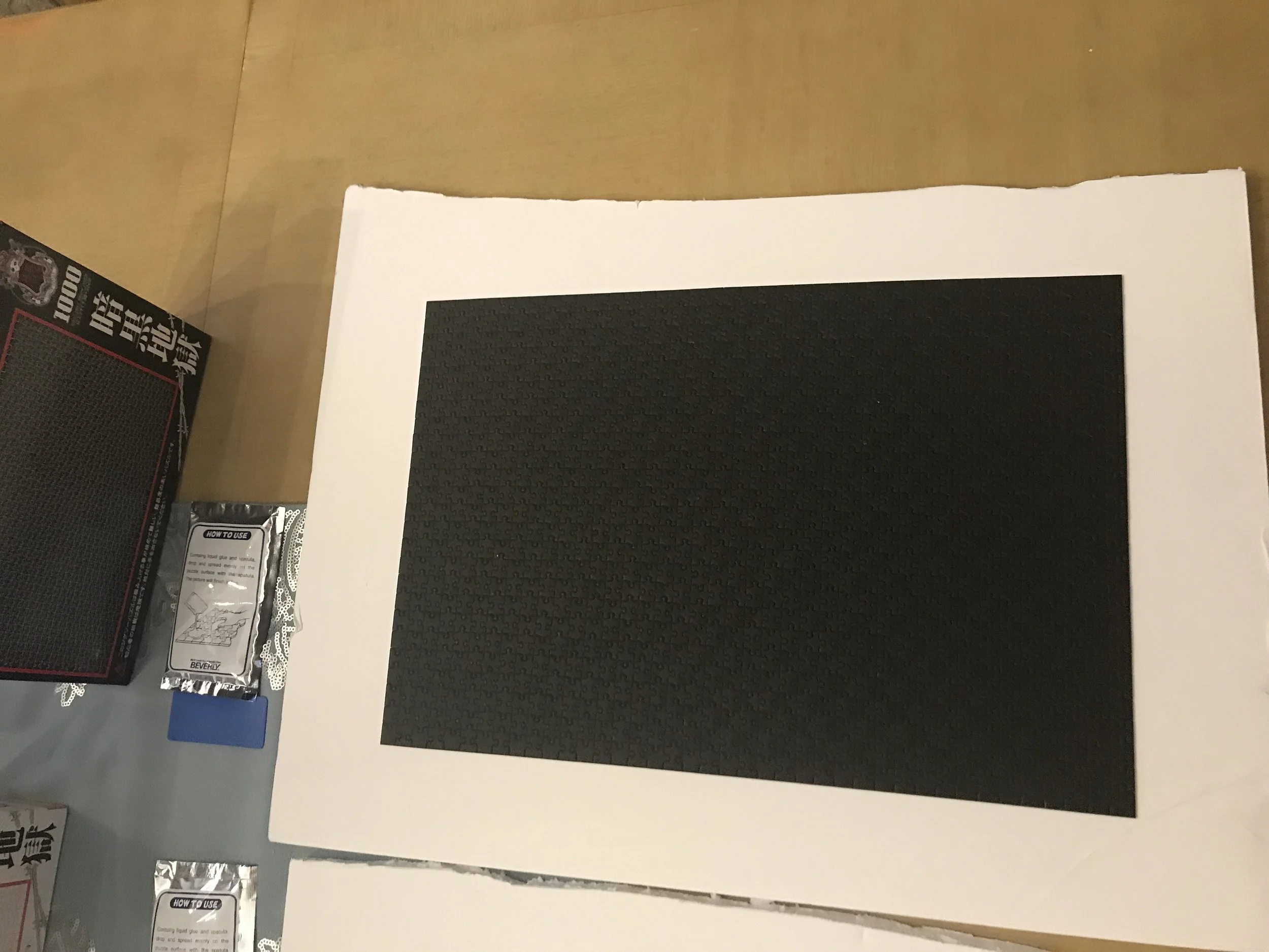 Jack Brait, aka Jack Of Puzzles, an all-black puzzle containing 1,000 tiny pieces.
