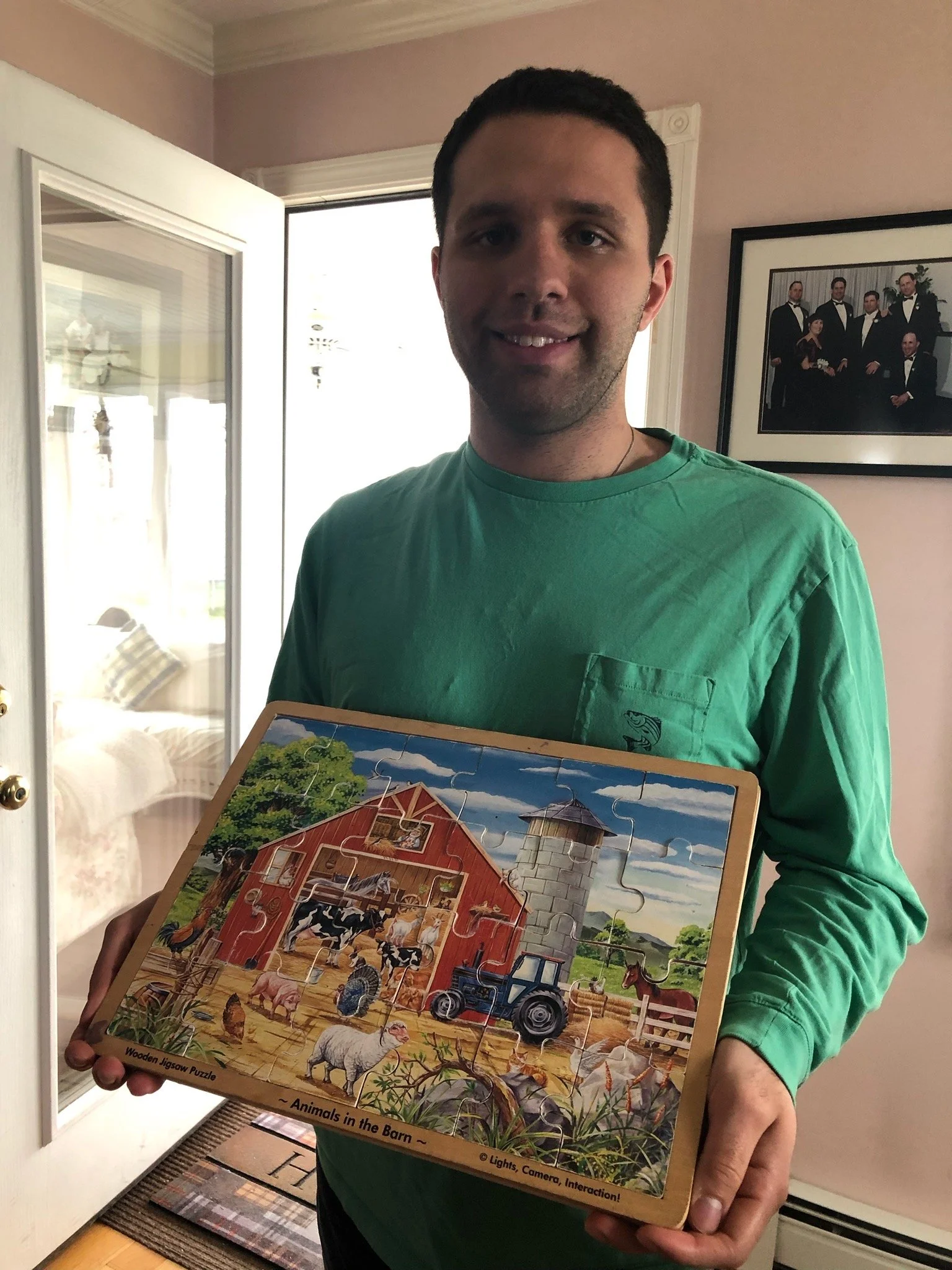 Jack Brait, aka Jack Of Puzzles, holding a wooden jigsaw puzzle he did when he was a little boy
