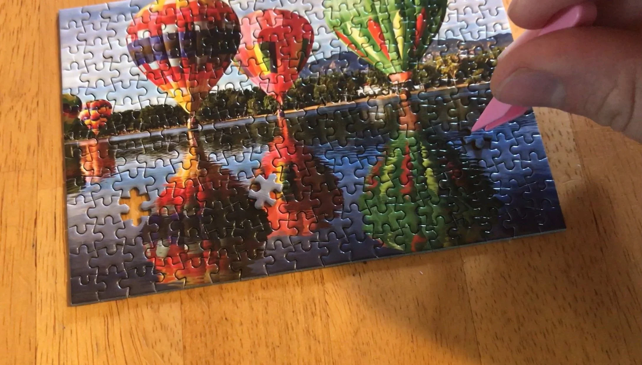 Jack Brait, aka Jack Of Puzzles uses tweezers to finish the world's smallest jigsaw puzzle.