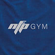 Close-up of a blue shirt with the NFP GYM logo in white.
