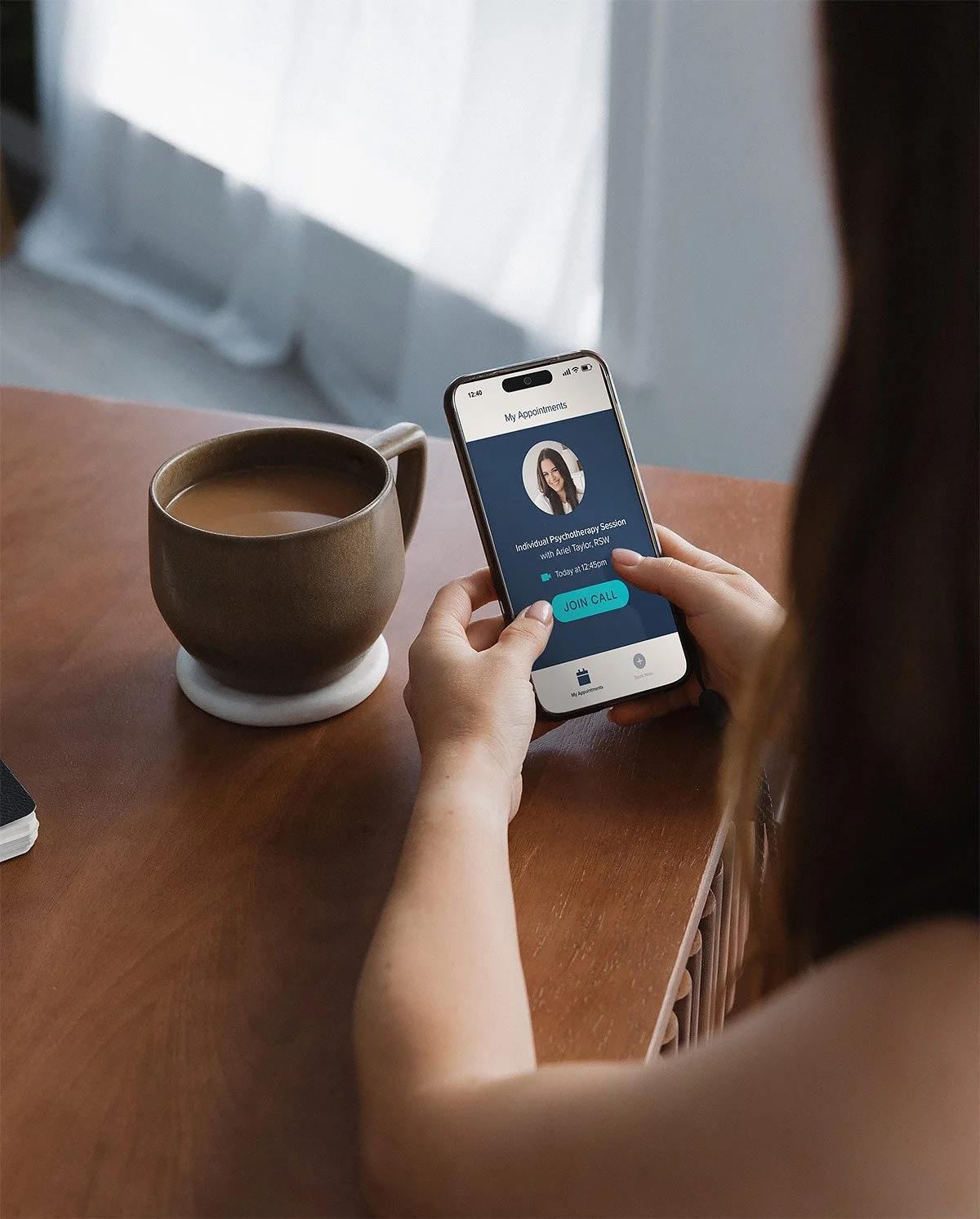 A person viewing a scheduled online therapy appointment on their phone.