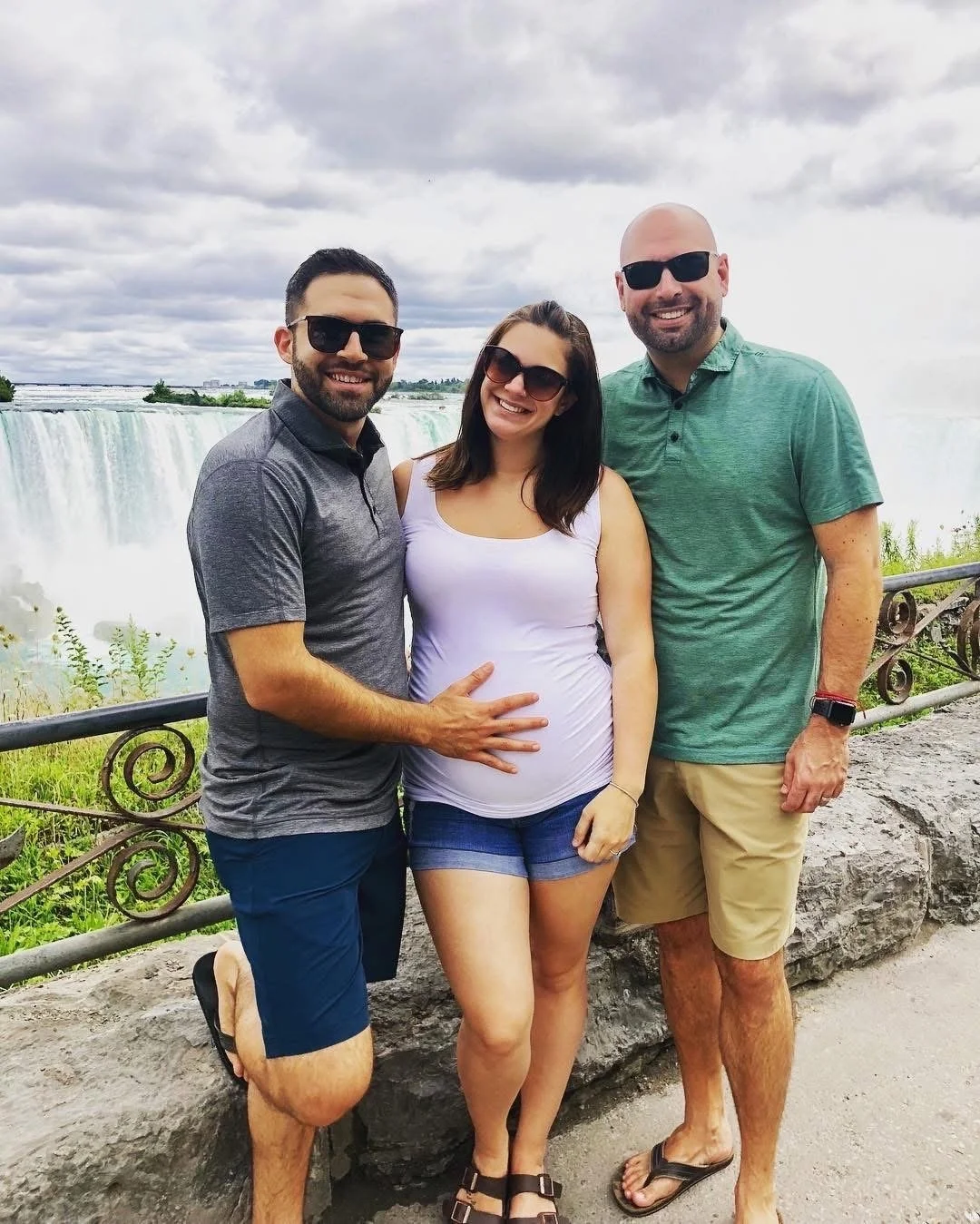 Surrogate and gay dads visiting together at Niagara Falls Canada during surrogacy pregnancy