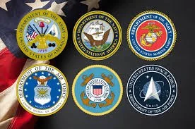 Six military badges arranged in a grid on a red and black background.