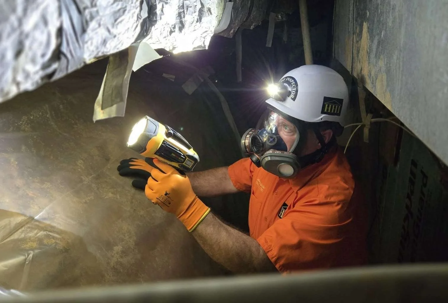 Owner Marc Holliday inspecting a crawlspace